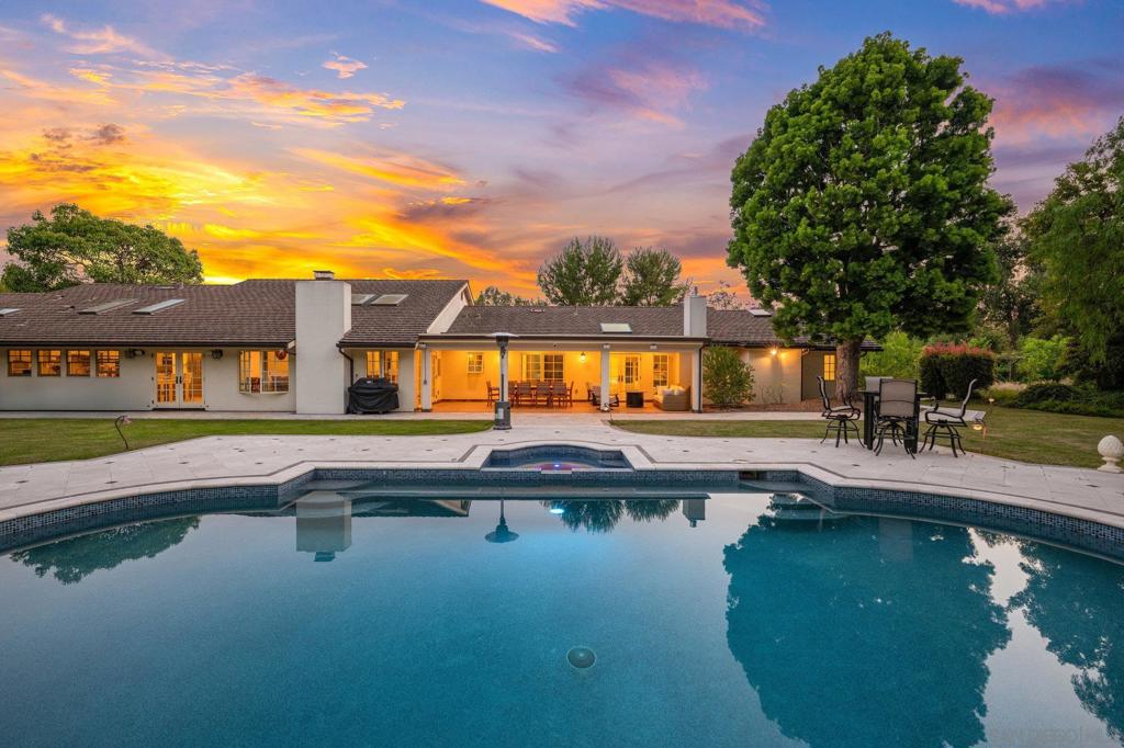 Experience elevated one-level living on 2.75 ultra-private, flat acres in Rancho Santa Fe’s exclusive Covenant. Rebuilt in 2017 with meticulous attention to detail, this 4,550 sq ft custom estate blends timeless European design with modern California ease. The open-concept floor plan features 5 en suite bedrooms and 5.5 baths, soaring ceilings, and expansive living spaces filled with natural light. The chef’s kitchen is a true centerpiece, showcasing sleek European cabinetry, top-of-the-line Miele appliances including dual cooktops and warming drawer, plus whole-home water filtration. A formal dining space and stone-clad fireplace anchor the seamless transition to the elegant family room, creating an inviting space for both entertaining and everyday living. Curated with designer stonework, custom fireplaces, and smart home features—including integrated speakers and security cameras—this home offers effortless sophistication. Outside, enjoy lush landscaping, a sparkling pool and spa, covered patio, and ample parking for up to 18 vehicles. A separate dog wash station with private access adds thoughtful convenience. Located on the desirable west side of the Covenant, minutes from Roger Rowe School, RSF Golf & Tennis Clubs, and village amenities. This is Rancho Santa Fe luxury at its finest—single-level, serene, and simply exceptional.