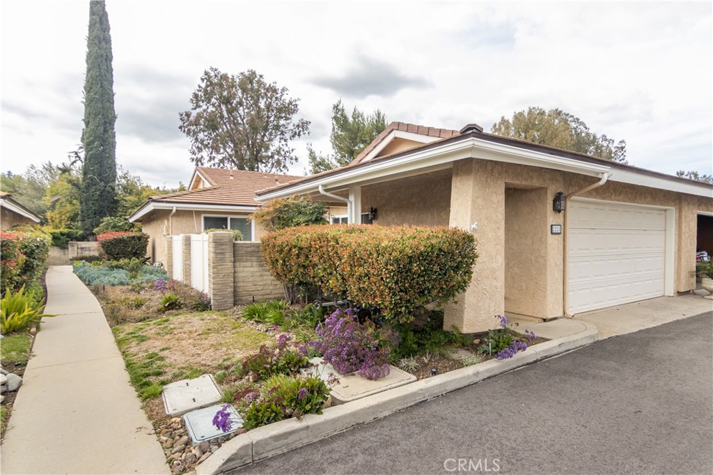 Location, Location, Location! In the heart of Westlake Village this single-story townhome features 2-bedrooms, 2 baths and is ideally situated at the end of a quiet, cul-de-sac with a sparkling community pool and spa.
Enjoy a lovely garden with an easy to care for drip system and stamped concrete patio. Once inside, you will be impressed by the open floor plan with a two-sided fireplace serving both the living room and dining room. Next, we have the large, remodeled kitchen and living room, featuring granite counter tops, subway tile backsplash, custom pullouts for easy access to large cupboard, and easy to care for wood plank flooring. This kitchen opens to an amazing back patio where you can entertain your guests or enjoy a peaceful evening by yourself. This spectacular home is close to shopping, fine dining, hiking, boating, biking.