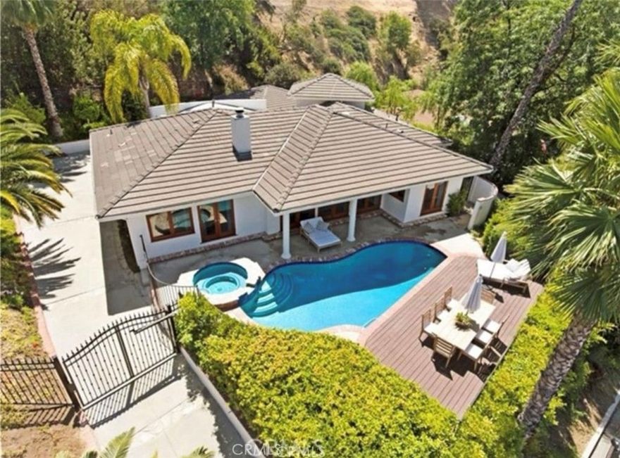 VIEWS,VIEWS, VIEWS, POOL HOUSE Located SOUTH of Ventura Blvd (Cul-de-sac) in one of Encino’s most desirable hillside neighborhoods, this SINGLE STORY modern retreat offers privacy, serenity, and breathtaking city views. Situated on a quiet cul-de-sac, the property is centrally located yet feels worlds away. Behind the gates, you’ll find a turn-key residence with high ceilings, abundant natural light, and seamless indoor-outdoor flow. The beautifully remodeled kitchen features a large center island, custom cabinetry, premium appliances, and a breakfast nook overlooking the backyard oasis. The formal dining room boasts soaring cathedral ceilings, perfect for hosting gatherings. The spacious primary suite opens to lush views of the pool and hills, complete with a walk-in closet and spa-like bath. Additional bedrooms are well-appointed and filled with light. A huge bonus space offers endless potential ideal for a home office, media room, or easily convertible into an ADU or additional 4th bedroom. Step outside to your private paradise: a sparkling pool, multiple lounging areas, and a tranquil backdrop of city lights. Perfect for entertaining or unwinding, this home blends comfort, style, and location in one exceptional package. A rare opportunity to own a gated, view-filled, modern home in the Encino Hills ready to move in and enjoy. Within Minutes to 101, Award winning Schools and Fine Dining