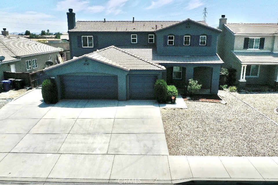 Discover the perfect blend of style and function in this stunning 3-bedroom, 3-bathroom, 2-story home in Adelanto. This property is a showcase of thoughtful design and modern living. Highlights include inviting living spaces beautifully finished floors that lead to a welcoming living room and a spacious family room. The family room, featuring a cozy fireplace, is perfect for relaxing evenings or entertaining guests. The open kitchen is a culinary haven, boasting sleek stainless steel appliances, elegant granite countertops, and plenty of room for cooking and gathering. Convenience at its best, a handy half bath on the main floor adds to the home’s practicality. Upstairs, you’ll find a flexible bonus room, three spacious bedrooms, and two full bathrooms, offering comfort and space for everyone. The indoor laundry room makes daily chores a breeze. Retreat outdoors to an expansive backyard, complete with a covered patio, an ideal spot for outdoor dining, entertaining, or simply relaxing in your private haven. Additional features include RV parking and a three car garage.