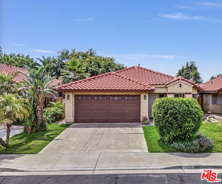 Step into this delightfully light-filled 3-bedroom, 2-bathroom gem nestled in a welcoming gated community. From the moment you arrive, you will feel the warmth of elegant laminate flooring that flows throughout the home, setting a tone of easy comfort and style. The spacious living room invites relaxation with its bright, open feel and charming double French doors that lead out to the backyard, perfect for morning coffee or winding down in the evening breeze. The kitchen offers a lovely balance of beauty and function, featuring attractive countertops and rich cabinetry that make both cooking and gathering a pleasure. Each bedroom is generously sized, with large windows that let the sunshine pour in, creating a cozy and uplifting atmosphere. The bathrooms are well-appointed, offering a clean and classic look to suit your everyday needs. Step outside to find a generous backyard with a welcoming patio, an ideal spot for dining al fresco or simply enjoying the fresh air. The community is thoughtfully designed with a serene, tree-lined park and a scenic walking trail that meanders through the neighborhood, perfect for leisurely strolls or peaceful reflection. This move-in-ready home blends charm, comfort, and practicality, truly a must-see!