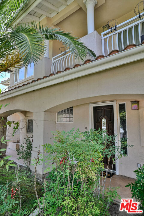 Rare opportunity to lease a front, street facing, tri - level townhome. Surrounded by verdant and mature landscaping, this Mediterranean style complex was built in 2005. Completely independent from the other units in the complex, #11 feels more like a single family home with only one common wall and has its own private entrance. The floor plan is open and airy, with extra high ceilings and plenty of natural light throughout. The living room fireplace (currently obscured by the tenant's television and console) anchors the room and rich hardwood and granite tile flooring lend an air of sophistication. Maple wood cabinets, granite counter tops and high end stainless steel appliances complete the chef's kitchen, which opens on to the dining room. Don't miss the discreet door giving access to the stackable washer / dryer closet! All three bedrooms upstairs have ample closet space. Enjoy the gentle breeze and the mountain views from the romantic covered balcony, exclusive to the principal bedroom which also features an en suite bathroom with spa tub, dual sinks, and a walk-in closet. There is direct access to the lower level comprising a two car, private garage and a versatile bonus room. Presently used as a storage space, it would make a great office or a gym. Public transportation and freeway access are minutes away as are the many shops, restaurants and countless unique and special amenities that Pasadena has to offer. Welcome home!