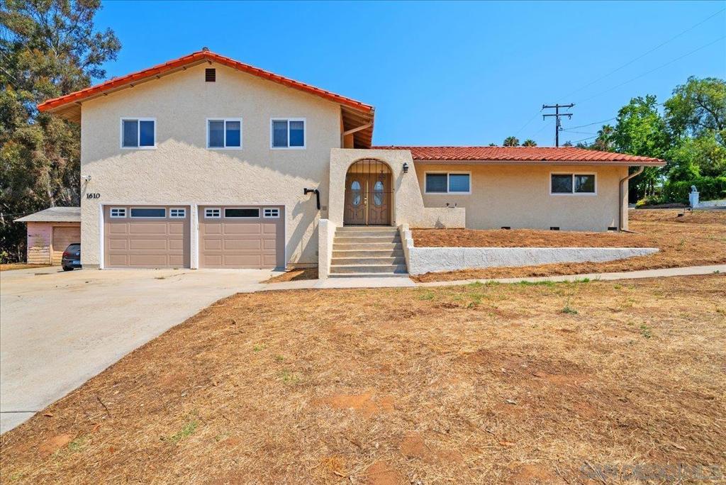 Welcome to 1610 Reche Rd, a split-level Spanish-style home, nestled in the heart of North Fallbrook. Owned and lovingly cared for by the same family for nearly 50 years, this unique property offers space, versatility, and endless potential—all just minutes from schools and the town center. The main home features 3 spacious bedrooms and 3 bathrooms, along with an optional bonus room perfect for a home office, guest space, or playroom. The inviting living room boasts a cozy fireplace and opens to a private balcony, ideal for enjoying peaceful evenings and hillside views. The separate dining room flows effortlessly into the well-appointed kitchen, complete with upscale appliances and ample cabinet space. A detached guest house offers added flexibility for extended family, rental income, or private studio use. Two newer outdoor storage sheds provide extra room for tools, hobbies, or equipment. Situated on a generous and useable 2-acre lot, the property is zoned for duplex units in any combination—an exceptional opportunity for multi-generational living, expansion, or investment. With space for horses, a grove, or garden beds, this property is a rare blend of country charm and in-town convenience. Don’t miss your chance to own a slice of Fallbrook history with this lovingly preserved and highly versatile home. Some rooms were Virtually Staged.