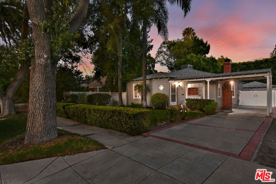 Tucked in the heart of Sherman Oaks just moments from premier shops and an array of fine restaurants 4226 Greenbush is a storybook cottage that perfectly balances urban living with the warmth of a neighborhood setting. From the moment you arrive, the home's inviting brick porch, porte-cochere, classic wood siding, and lush garden filled with wildflowers and roses create a curb appeal that is nothing short of enchanting. Step inside and you're welcomed by a formal entry leading to sun-drenched living spaces. Gorgeous engineered wood floors and oversized picture windows bathe the rooms in natural light, enhancing the home's warmth and charm. The living room, anchored by a striking brick fireplace, flows seamlessly into the formal dining room - an ideal setting for both intimate gatherings and lively dinner parties. At the heart of the home lies the beautifully remodeled kitchen, finished with quartz countertops, subway tile backsplash, stainless steel appliances, and custom wine storage. A convenient breakfast bar opens to the spacious family room, where French doors extend the living space outdoors to a covered patio of approximately 250 square feet. Here, alfresco dining and casual entertaining unfold against the backdrop of a private, magical garden - an idyllic retreat for weekend brunches, wine nights, or simply relaxing with friends. And for a bonus, there's a detached room right off the garage, perfect for an office, or creative space. Back inside, and down the hall, two generous bedrooms await, each paired with a stylishly appointed bath. The primary suite offers a private sanctuary with French doors opening directly to the garden, creating a serene connection to nature. And when it's time to dine out, shop, or explore, you're only steps away from the vibrant lifestyle Sherman Oaks is known for. 4226 Greenbush is more than a home - it's a seamless blend of charm, convenience, and location!