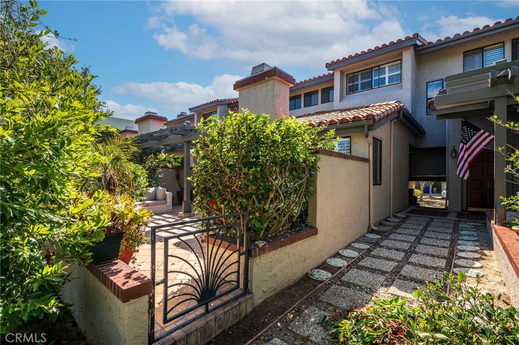 Discover the charm of this sought-after Plan 3 Court Townhome in the exclusive, gated community of Manhattan Village—just under two miles from the beach. This home features three bedrooms, including two spacious primary suites, each with a walk-in shower, walk-in closet, and dual-sink vanities with marble countertops. The third bedroom is perfect as a home office or guest room. A versatile bonus storage/playroom off the stairway landing offers space for hobbies, crafts, or seasonal items.
The inviting main level boasts an open living room filled with natural light, opening to a private patio with a built-in BBQ. The kitchen is well-appointed with premium stainless-steel appliances (Wolf range, built-in refrigerator, and dishwasher), and direct access to a roomy two-car garage.
Residents enjoy access to community amenities, including a resort-style pool and spa, a recreation room, picnic areas, beautifully landscaped greenbelts lined with magnolia trees and direct access to Manhattan village mall. Experience coastal living in this meticulously maintained private community.