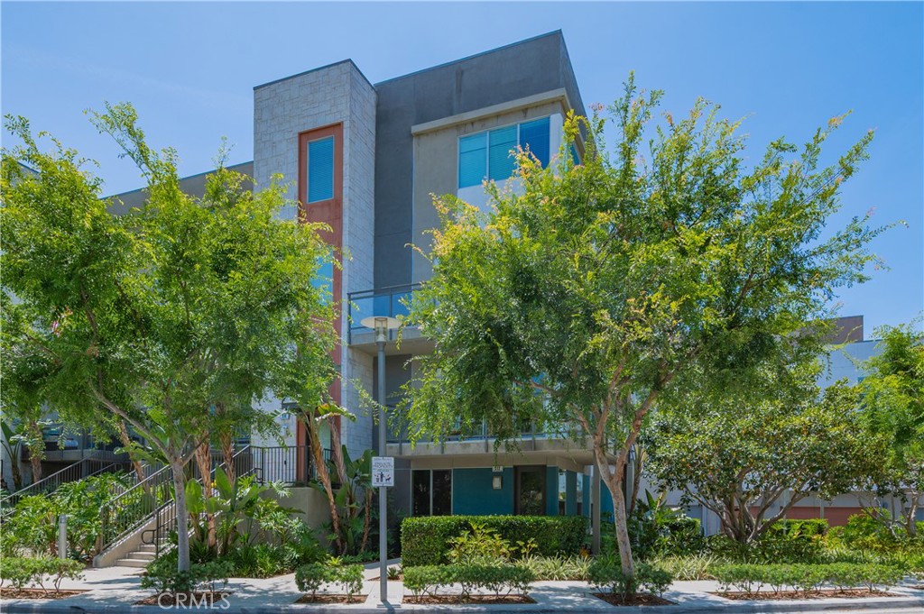 Turnkey townhouse-style property located in the heart of the Irvine Financial District. Situated on a private corner parcel with lush landscaping, an open floor plan spanning approximately 1832 square feet with MINIMAL STAIRS. The property offers the optimal indoor-outdoor living experience. Inside this spacious three bedroom three full bath home discover open and airy living spaces highlighted by city and garden views, custom hardwood flooring, designer tile, plush carpet, custom interior paint, custom window treatments, recessed lighting, upgraded chandeliers, custom built-out closets, Nest Climate Control, Ring Video Doorbell and more. The entire property has been thoughtfully designed. The chef's kitchen features a large island, quartz countertops, a quartz backsplash, a walk-in pantry, and stainless steel appliances. The open kitchen concept allows for seamless entertaining. Featuring a multitude of windows for exceptional light and a large wrap-around viewing deck that captures Irvine Financial District views. This deluxe property also features an oversized, finished, side-by-side private two-car garage with epoxy flooring, custom cabinetry, and direct access to the home's interior. 5-Star amenities at Central Park West include two resort-style saline pools and spas, an 8000 square foot gym and fitness facility a community event center, two parks and a pickleball court. Convenient to Fashion Island Newport Beach, South Coast Plaza, UCI, John Wayne Airport, and OC beaches