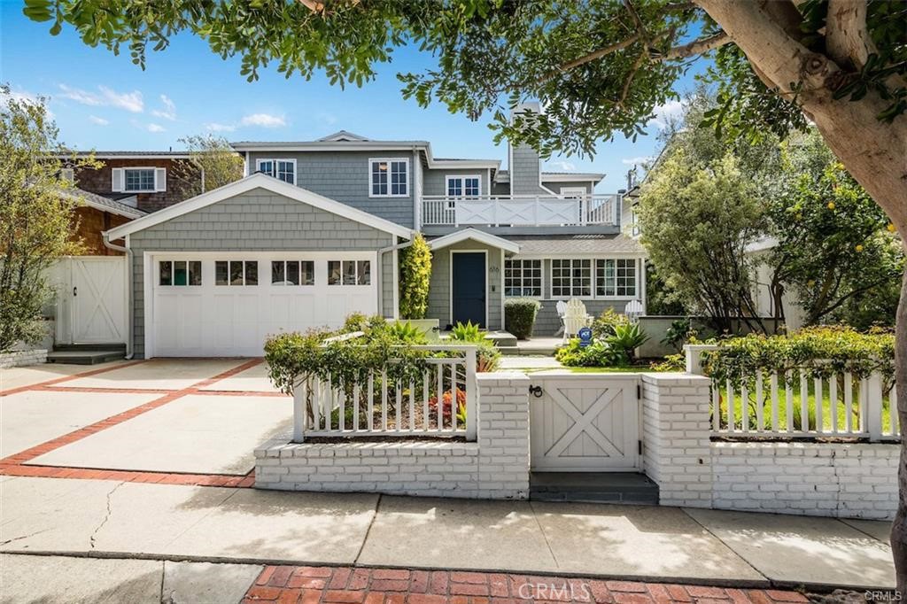 Coastal charm abounds in this beautifully modernized grey-shingled Cape Cod nestled in among one of Manhattan Beach’s best-loved neighborhoods. From the warm welcome of the sunny formal living room with corner fireplace to the generous gourmet kitchen and sprawling backyard, this home radiates warmth and hospitality, as well as an impressive layout. A formal dining alcove peeks into the adjacent family room, which has board and batten walls and a lovely center fireplace. Double sets of French doors open onto the gorgeous backyard, which features an outdoor fireplace, dining area and spacious turf lawn. Mature trees and landscaping ensure peace and privacy on all sides. The kitchen offers stainless appliances, a center island with counter seating and a breakfast nook with built-in benches. A total of five bedrooms and four baths are characterized by gleaming wood floors and designer touches such as custom cabinetry, enchanting wallpaper and elegant fixtures. The first floor also includes two bedrooms with Jack-and-Jill bath, a laundry room, den and powder room. The second floor is home to a grand primary bedroom with two decks, fireplace and gorgeous spa-like bath. Two additional bedrooms and a beautiful full bath complete the upstairs living spaces. Entirely updated and brimming with coastal elegance, this home is steps from the Badminton Club and Live Oak Park and just a short walk to town, local schools and the sparkling white sands of Manhattan Beach.