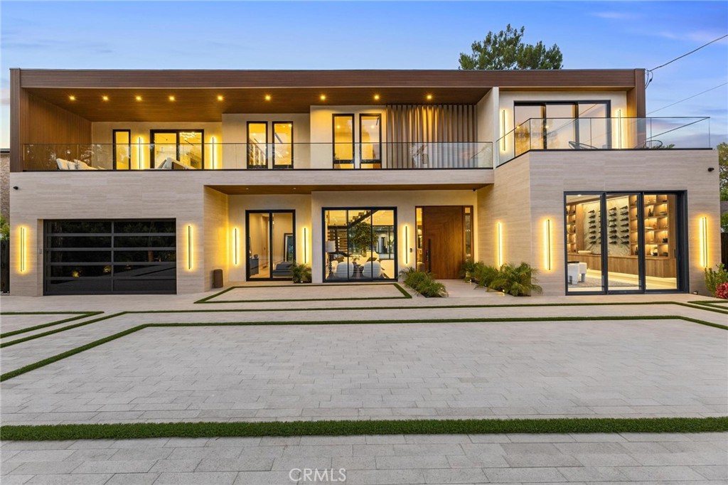 Modern Marvel in Tarzana | Brand-New Gated Estate South of the Boulevard. Set behind private gates and located South of the Boulevard in Tarzana, this brand-new modern estate offers sophisticated style, high-end comfort, and impeccable attention to detail. With 6 bedrooms and 7.5 bathrooms, this thoughtfully designed home delivers both elevated entertaining spaces and intimate retreats. Step through the grand 10-foot solid wood pivot door and enter a light-filled, open-concept floor plan designed for seamless indoor-outdoor living. A stunning floating staircase and custom atrium with a dramatic faux tree serve as focal points of the main level, creating a unique sense of balance and calm. Just off the entry, a cozy sitting area provides the perfect space to unwind or welcome guests. The expansive family room features a sleek fireplace and massive pocket sliding glass doors that lead to an oversized covered patio—complete with built-in heaters and BBQ, ideal for year-round gatherings. The gourmet kitchen is a chef’s dream, outfitted with Dacor appliances, built-in refrigerator and freezer, full-size wine fridge, and a fully equipped butler’s pantry with espresso machine, sink and secondary dishwasher. A formal dining room with custom cabinetry, media room with projector and screen, and a private office add flexibility to the main floor, along with a convenient downstairs bedroom with en-suite bath. Upstairs, four spacious en-suite bedrooms include access to multiple balconies that invite fresh air and natural light into every corner. The luxurious primary suite boasts a fireplace, pocket sliding doors opening to a private terrace, and a custom walk-in closet complete with built-ins, jewelry drawers, and a backlit vanity. The spa-like primary bathroom features double sinks, a freestanding soaking tub, oversized double shower, and an infrared sauna—offering a retreat that rivals any five-star resort. The outdoor space is an entertainer’s dream, with a sparkling pool and spa, a basketball sport court, and a stunning recreation cabana with bi-folding glass doors on three sides for the ultimate open-air lounge experience. A beautifully finished detached ADU completes the property, offering 1 bedroom, 2 full baths, full kitchen, and in-unit laundry—perfect for guests or extended family. Finished with a Control4 smart home system, custom lighting throughout, and ultra-premium materials, this one-of-a-kind estate sets a new bar for modern luxury living in Tarzana.