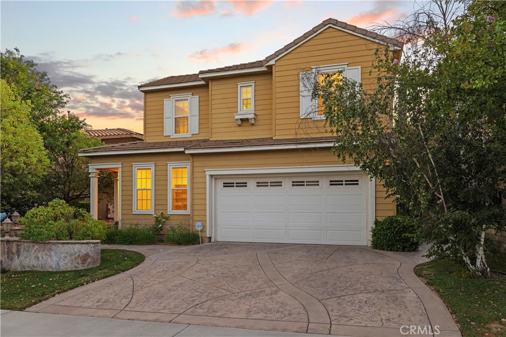 Welcome to this stunning 5 bedroom, 3 bath home with 2,752 sq ft of living space, located in the highly sought after gated Sundance tract of Valencia Westridge. Set at the end of a cul de sac, this residence blends space, style, and comfort in one of Santa Clarita’s most desirable communities served by award winning Oak Hills Elementary, Rancho Pico Junior High, and West Ranch High School. The beautifully designed front yard features impressive hardscape with lighting, a stamped concrete path, and a stamped concrete driveway that elevates curb appeal. Inside, the main level offers a full bedroom and bath, a formal living room, and a formal dining room with a butler’s pantry that flows into the light filled kitchen. Here, you’ll find a spacious island, dual ovens, abundant counter space, and plenty of cabinetry, all opening to an expansive family room. Upstairs offers newer carpet, three generous guest bedrooms with a dual vanity bathroom, a convenient laundry room, plus a luxurious primary suite with a large walk in closet, dual vanities, and a spa like bath with a jetted tub and separate shower. Outside, entertain with ease under the shaded patio cover complete with a built in BBQ and sink. Additional highlights include a 3 car garage. Life in Westridge means access to resort style amenities including two pools, tennis and sports courts, and a clubhouse, all surrounding The Oaks Club at Valencia where golf and social memberships await. Low HOA, no Mello Roos, and minutes to the 5 freeway make this the perfect package.