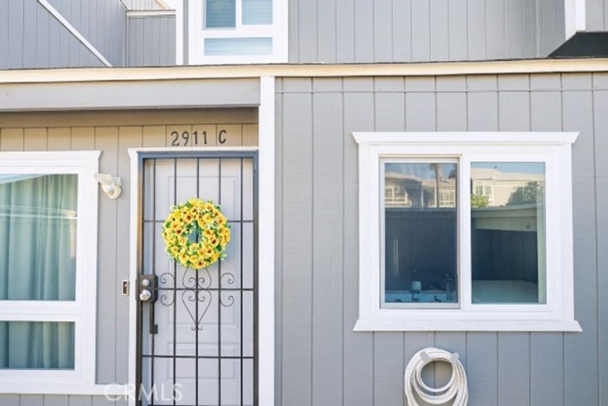 NEW ROOF (approximately 2 months old)! Turnkey townhome located in the highly desirable Village Walk Townhome community featuring 2 bedrooms and 1.5 bathrooms with vaulted ceilings and abundant natural light. The bright, open floor plan offers quartz countertops with a tile backsplash, a chandelier over the kitchen sink, step-in pantry, recessed lighting, and under-cabinet motion-sensor lighting. The living area is enhanced with wainscoting, crown molding throughout, new baseboards, tile flooring on the main level, and carpeted stairs and bedrooms. The upstairs bathroom features tile flooring, and the primary bedroom includes a walk-in closet with mirrored door. Additional highlights include solid core interior doors, mirrored bypass closet doors, newer windows and sliding glass door (approximately 2 years old), real wood decking freshly painted as a custom upgrade, ceiling fan in dining area and attic access. The home also features a Ring doorbell (to remain), security door, Google Nest thermostat, electric tankless water heater (approximately 3 years old), and central AC (installed 2010). The 2-car attached garage offers direct access (with exterior keypad entrance too) and interior laundry hookups. Community amenities include a pool and landscaped greenbelts. Conveniently located near South Coast Plaza, Segerstrom Center for the Arts, OC Fairgrounds, major freeways, John Wayne Airport, and the coastal destinations of Newport Beach and Huntington Beach.