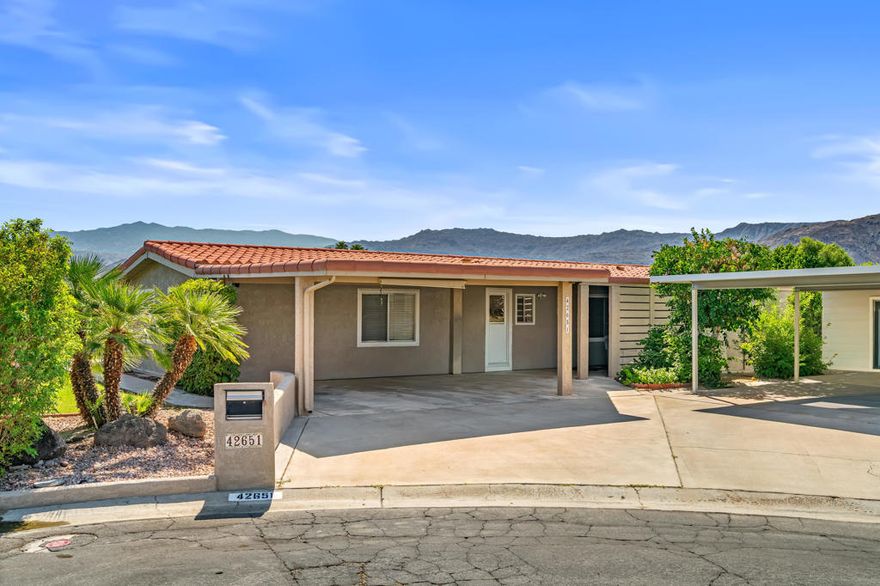 Beautifully maintained home in the popular Portola Country Club. This property is located at the quiet end of a cul-de-sac and offers outstanding mountain views to the south and west. Inside, the home features an open plan kitchen/dining room, large living room, two bedrooms, two bathrooms, and laundry area.  The outside offers a tiled roof, stucco exterior, storage shed, an additional workshop, two carport spaces, two private side yard areas, and covered patio. Located close to the clubhouse, pool, tennis court, and golf course. Fee land and low HOA fee of $440/month.