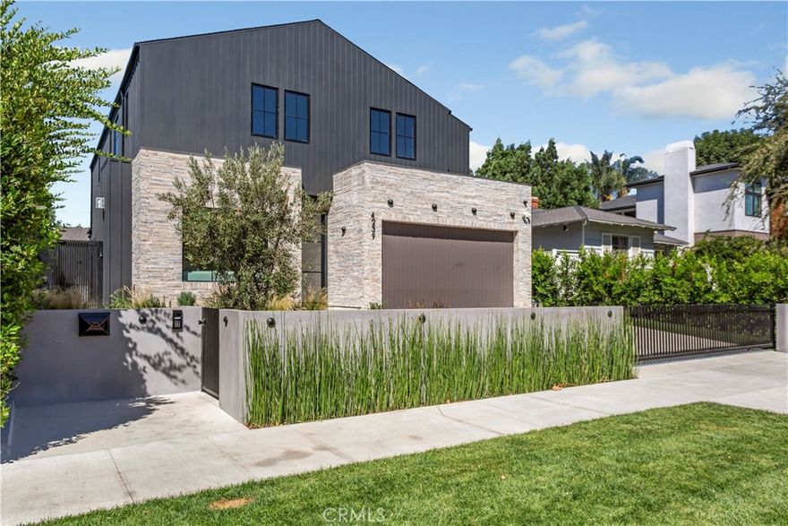 This stunning new construction minimalistic modern residence is located in the highly sought after Studio City "FOOTBRIDGE SQUARE" neighborhood, in Carpenter Charter Elementary School District and walking distance to the finest dining and shopping in the City. This SMART HOME is equipped with a CONTROL4 HOME AUTOMATION SYSTEM, and meticulously crafted with style and the highest quality materials. The interior appointments include wide plank European White Oak floors, Bespoke Cabinetry, white oak wall and ceiling surfaces, with Lime Wash Faux finish walls/ceiling throughout. Living room with large picture window, elegant formal dining room, designer kitchen features SUB ZERO/WOLF appliances and includes a breakfast nook. All bedrooms are en-suites and the luxuriously appointed primary suite includes vaulted ceilings, walk-in closet, custom built-in cabinets and an opulent spa like bathroom with oversized shower. The surprisingly spacious back yard rarely found in new construction homes is extremely private and features an open trellis patio, built-in BBQ, 2nd seating and dining area, an abundance of grass and a French grey plastered pool/spa with 3 water features. The fully equipped detached ADU has a complete bedroom suite, full size kitchen and large living room with vaulted ceilings and glass sliding doors. Please see private remarks for additional listing information.