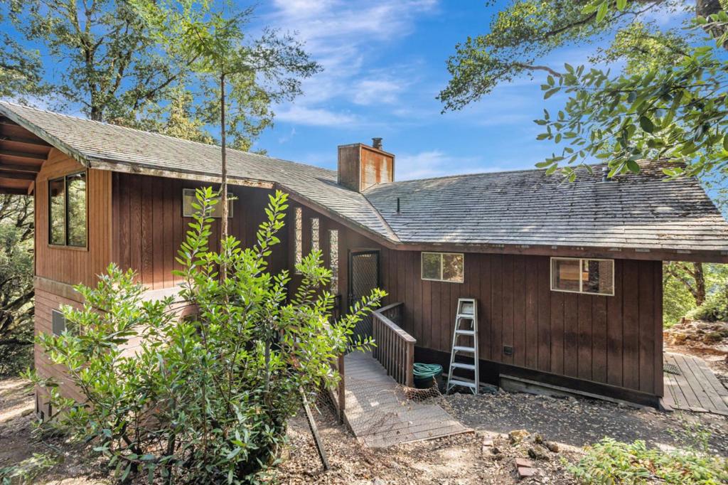 Discover the perfect balance of mountain retreat and Silicon Valley convenience in this Los Gatos home with breathtaking views of Monterey Bay. Nestled in a peaceful, secluded setting, this property offers easy access to Bay Area tech campuses as well as a quick drive to the coast for days at the beach. Inside, you'll find a light-filled interior with vaulted ceilings and stylish glass block windows that create an airy, open feel. The kitchen is a true highlight, featuring gleaming granite countertops and stunning solid hardwood cabinetsbuilt to last and beautifully crafted. The home is part of the highly sought after Las Cumbres HOA that provides valuable community benefits, including paved roads, organized neighborhood events, and the added security of a nearby fire station. Community amenities also include pool, community center, community garden, bocce/basketball/tennis courts and More than 1200 acres explorable shared conservation land.Whether you're seeking tranquility in nature or proximity to work and recreation, this home offers the best of both worlds.