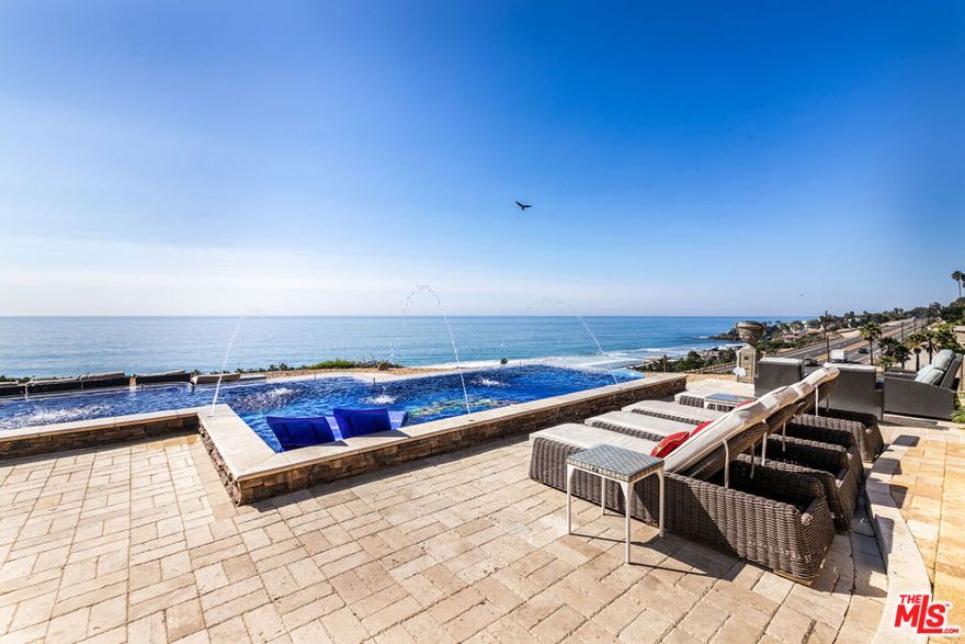 At the end of a cul de sac street and down a long private drive, sits this 5 bedroom 7 bathroom main house plus detached 2 bedroom one bath guest house on a bluff above the Ocean with 180 degree ocean views. Home has vaulted cathedral ceilings, gorgeous stonework throughout, an open Chef's kitchen, with all high end appliances, beautiful outdoor kitchen complete with Wok, BBQ, refrigerator and bar area. Plus a Vegas style pool with deck jets, jacuzzi and in-water lounging area. A newly completed home theater, family room, kitchenette/ bar and 1/2 bath make up the area above the 3 car garage. A separate bedroom that can be used as a maid's room is attached to main house but has a separate entrance. Main house has 5 bedrooms and 7 bathrooms plus great room, formal dining, office and kitchen open to the family room and most rooms have ocean views. Up the drive near the street sits the almost, 900 sq ft Guest house, plus an additional 2 car garage with views from every room. Vaulted high ceilings, open kitchen and master on main level with direct entrance to patio, plus a second story guest suite. Wrap around decks and separate garage for the guest house. It is far removed from the main house and could make a nice rental unit. Only one neighbor on one side, the other 3 sides are bluff, ocean views and privacy. This house has it all. Views, pool, spa, home theater, guest house, plus the entire house and guest house come fully furnished. Total square footage of 4,812 includes the main house (3,912 sq ft) and the guest house (900 sq ft).