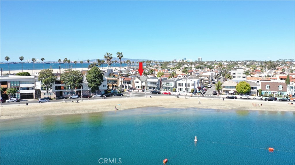 Rarely on the market Beach front Spanish Duplex that has been upgraded throughout!
A gorgeous shoreline gem that sits proudly across from Alamitos Bay and just short steps from the sandy beach. The sizeable 2 bedroom, 1 bathroom upstairs unit features beautiful hardwood floors throughout, a living room plus a small office space with panoramic beach views, and a formal dining room. The kitchen has been remodeled with newer high-end appliances, a small in-unit laundry area with hookups for a stackable washer & dryer, and lastly a large patio area/back deck off the kitchen that is great for entertaining. The spacious 1 bedroom, 1 bathroom downstairs unit boasts those beautiful hardwood floors again, a huge living room with expansive bay views and a warm romantic fireplace. The kitchen has been remodeled with high-end appliances and eat-in dining, a small in-unit laundry area with hook ups for a stackable washer and dryer. Additionally, this beautiful beachfront building includes an expansive brick beachfront deck ideal for breathtaking ocean views and unforgettable entertainment, a large 2-car garage, upgraded electrical panels, dual pane windows throughout, central heating and more! Residents of this beautiful duplex can enjoy swimming and windsurfing in the bay, sailing the swells, sunbathing in the warm sun by the shore, taking a short stroll 2nd Street for its unique boutiques, restaurants, and entertainment spots, as well-as the other endless amenities that the community of Belmont Shore has to offer. Ideal for owner-occupancy with a beautifully appointed unit to call home while generating income from the other or this stunning two-unit property also offers the potential to be converted into a spacious single-family home. Don’t miss this rare opportunity!