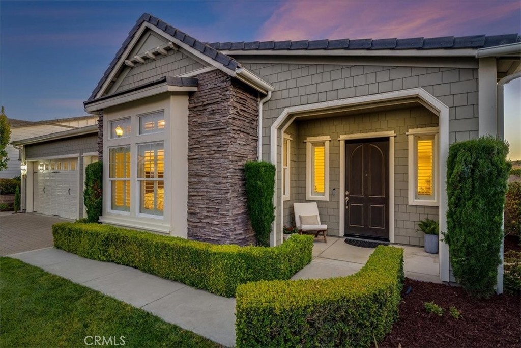 Experience the charm of this English Coastal Cottage blended with executive-level luxury, located at the end of a quiet cul-de-sac at the prestigious Monarch Dunes Golf Course Resort. This stunning Morro Model home offers approximately 2,812 square feet of thoughtfully designed living space on a generous 9,474 square foot pie-shaped lot. With 3 spacious bedrooms, 2.5 bathrooms, a formal dining room and gathering nook with a dual-sided fireplace, this home is tailored for both comfort and entertaining. Step outside into an oversized, professionally landscaped backyard oasis designed to accommodate fabulous outdoor living. Highlights include a custom built-in barbecue, putting green with turf grass, large outdoor spa, mature trees, and a covered patio—perfect for warm summer nights and holiday celebrations. The open floor plan is bathed in natural light from expansive windows, offering panoramic views of the golf course and breathtaking sunsets from the moment you step through the front door. The kitchen is designed to be the heart of the home, and features Monogram stainless steel appliances including double ovens, a built-in side-by-side refrigerator, gas cooktop, microwave, slab granite countertops, a large center island and two walk-in pantries. The great room and den provide ample space for gatherings of any size. When you are ready to relax, primary suite is privately situated at the rear of the home, offering tranquil golf course views and a luxurious ensuite with a large soaking tub, separate shower, dual vanities, custom tile work, and a spacious walk-in closet. With extensive upgrades, including owned solar, air conditioning, new water heater, and new outdoor lights, this home offers both elegance and efficiency. Located within Trilogy at Monarch Dunes, this property is part of a vibrant resort-style community that celebrates lifestyle living with world-class golf, scenic trails, fine dining, and engaging social events. Come discover the perfect blend of sophistication, comfort, and coastal beauty.