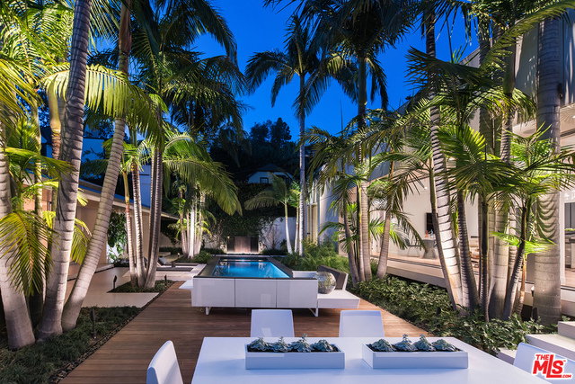 A rare contemporary estate situated just above the Sunset Strip in prime lower Bird Streets. Gated and completely private, this award winning residence is divided into two structures separated by a tropical landscape with an abundance of space for entertaining. The main home features a gourmet kitchen, family room, media room, dining room and a spacious living room set against book-matched Calcutta walls. Sliding glass doors lead to an outdoor oasis with a pool, spa, bbq and IPE decking. The secondary structure is an entertainers dream, serving as a guest house and pool house with a full kitchen, bar, gym, rooftop deck and a 7 car garage with a turntable at the entrance.