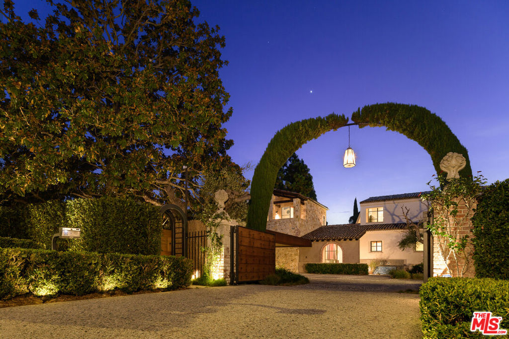 Designed by renowned architects Luis Ortega and Jose Fernandez, this custom-built significant Beverly Hills masterpiece showcases an interplay of varying roof angles combined with natural stone to give the exterior a monumental presence. Exquisite materials from the rustic wood beams and steel-cased windows to the outdoor patios and decks create areas for entertaining and views of the property and gardens. A glass foyer leads to earth tones of stone, wood, steel, and glass. An open floor plan creates a sense of volume and serves as an extension of the exterior setting and expansive pool deck and cabana. The main level offers a large formal dining room, an office/library, and a complete guest suite. Also on the main level is the primary bedroom suite with vaulted ceilings, floor-to-ceiling windows, and a two-bathroom suite with a spacious marble shower, a large sitting bath, and his & hers walk-in closets. The custom chefs kitchen features Miele, Sub-Zero, and Kuppersbusch appliances that lead to a dining and living area that opens to the outdoors. Upstairs you'll find two guest casitas with the option for an office or home gym and an observation deck overlooking Beverly Hills and city views.