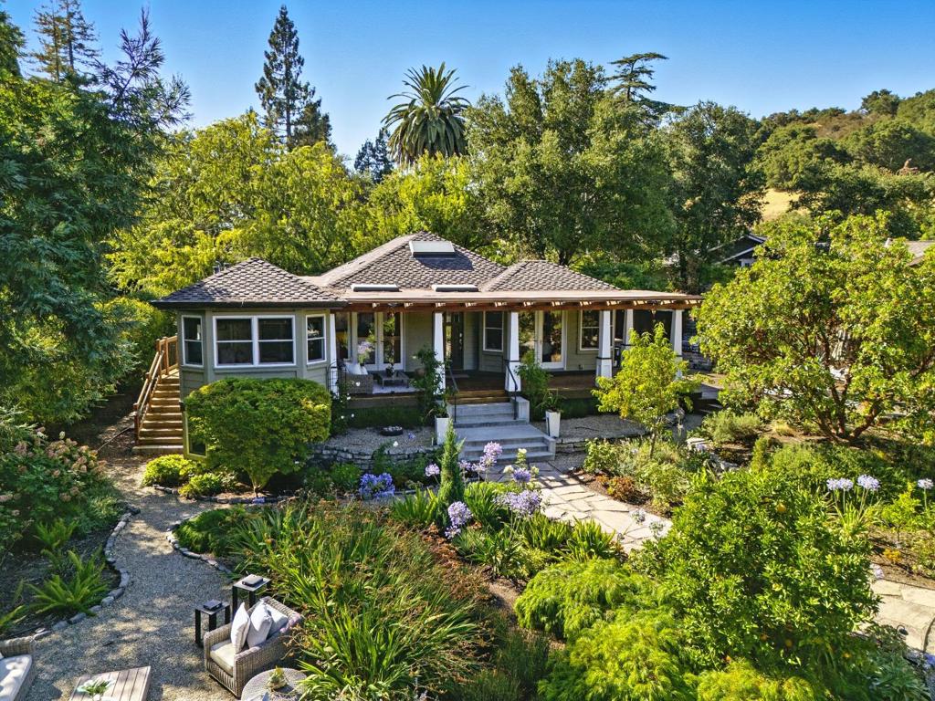Hidden gem on nearly half an acre nestled behind a private gated entry. Professionally landscaped grounds feature mature orchard trees and an abundance of flowers blooming year-round. This exceptional single-level residence blends elegance, style, and comfort in a thoughtfully remodeled, open, light-filled floor plan. The grand entry opens to a spacious living room with custom built-in cabinetry and designer lighting, flowing effortlessly into the chefs kitchen, complete with a large center island, premium Thermador appliances, and an inviting dining area. French doors lead to an expansive lanai, ideal for quintessential California indoor/outdoor entertaining. The primary suite is a private sanctuary, with designer touches and high-end finishes. Outdoor living spaces included multiple seating areas, an outdoor kitchen, and a gas fire pit. The detached garage offers over 500 square feet of versatile space, perfect for a guest suite or home office. Additional highlights include a private well, potential to add an ADU, or expand further. Perfectly situated walking distance to the Village restaurants and shops. Close to hiking and biking trails, Edgewood Park, Stanford University, major tech campuses, and Interstate 280. Highly regarded Woodside schools.