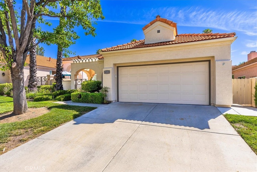 Move-in ready and beautifully maintained, this charming home boasts a bright interior with vaulted ceilings! Located in the highly desirable 55+ gated community of The Colony, this truly TURN-KEY, single-story offers residence a rare opportunity to experience upscale, active, adult living in one of America’s safest cities. Thoughtfully designed for comfort and entertainment, the home features 2 bedrooms, 2 updated bathrooms, a spacious living room, with a bright and airy atmosphere throughout. Upon entry, you’ll be greeted by a large and inviting gated courtyard leading to the front door. The cozy living area features a fireplace, creating a perfect spot for relaxation. The updated kitchen is equipped with modern appliances, new cabinetry, sleek counter-tops and a convenient breakfast nook. Wood tile flooring throughout adds both style and durability. The primary suite offers a private retreat with new windows and carpet. The updated en-suite bathroom is complete with a shower and dual sinks. The additional bedroom is generously sized and share a well-appointed updated second bathroom. The home features a two-car attached garage and a private backyard space with new iron fencing and gate leading to a walking path. Residents of The Colony enjoy access to pickleball, tennis, bocce ball, a sparkling pool and spa, and a scenic golf course that winds through the community. Don’t miss this opportunity to live in one of the area’s most desirable 55+ neighborhoods!