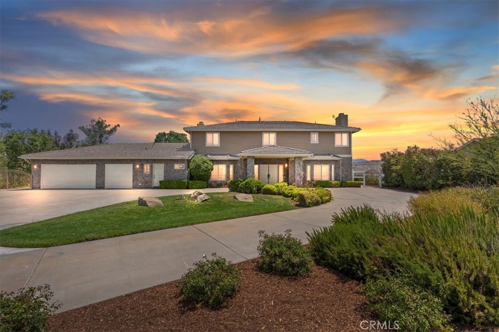 Welcome to this immaculate custom estate perfectly situated on 2.5 acres with breathtaking panoramic views of the Temecula Valley and its iconic hot air balloons. Located just minutes from town and the area’s award-winning wineries, this stunning home offers the ideal blend of privacy, space, and convenience. Featuring approximately 3,858 sq ft of beautifully upgraded living space, this residence includes 5 bedrooms, 4.5 bathrooms, and a dedicated office with built-ins that could serve as a 6th bedroom. From the moment you arrive, the stately presence is undeniable—stone-accented exterior, private wrought iron electronic entry gate, porte cochere, mature trees, and a double door entry that leads into a warm, elegant interior.
Inside, you'll find a spacious, open layout with hardwood flooring, new downstairs carpet, crown moulding, coffered ceilings, picture windows, and French doors that frame incredible views. The home features three fireplaces—located in the living room, family room, and the primary suite—adding warmth and sophistication throughout. The gourmet kitchen includes granite countertops, custom cabinetry, double ovens, and a charming morning room filled with natural light and scenic beauty. The primary suite includes a fireplace, walk-in closet, and a beautifully upgraded bathroom featuring elegant finishes, plus a new soaking tub. French doors lead out to a private balcony with wrought iron railings and a staircase offering direct access to the backyard—ideal for enjoying peaceful mornings or quiet evenings. Secondary bedrooms are generously sized, including a Jack-and-Jill configuration upstairs for added functionality. Step outside to a backyard designed for comfort, entertaining, and enjoying the wine country lifestyle. The custom saltwater pool and spa are surrounded by lush landscaping, mature trees (including numerous fruit trees), and open space to unwind or gather with friends. The expansive 2.5-acre lot provides ample room for horses, a sport court, or a future guest house—plus, there's convenient secondary access to the lower part of the property from the road behind. Additional highlights include RV parking with 220V hookup, an oversized three-car garage with built-in cabinets, a custom 8–10 person sauna, and included refrigerator, washer, and dryer. With no HOA and low taxes, this exceptional property is a rare opportunity to enjoy the very best of Temecula’s lifestyle, space, and views.