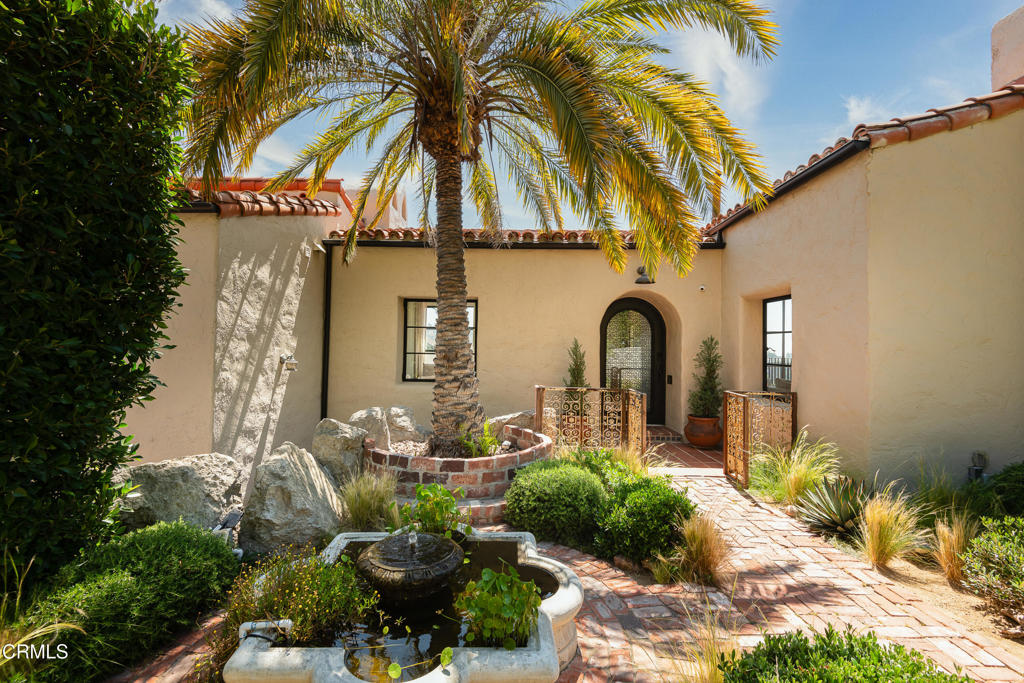 This beautifully renovated 4-bedroom, 4-bathroom Spanish estate with breathtaking views and original details throughout, including a Batchelder tile staircase, hardwood floors, expertly landscaped exteriors, and multiple patios and viewing decks.The living room is filled with natural light, with vaulted ceilings, and floor-to-ceiling glass doors that open out to a massive viewing deck with mountain and city views. The kitchen comes with Miele appliances and an adjacent dining area leads out to another patio with a barbecue grill and bench seating. Downstairs, there are three bedrooms, including the primary suite complete with a luxurious bath with large walk-in steam shower and walk-in closet. A guest suite with its own entrance, with an en-suite bathroom and kitchenette serves as the perfect gym or studio. This stunning property has been updated with modern features: a smart home system, Miele appliances, gated/controlled entry, dry sauna, a laundry room with two washers and two dryers, and the exterior is gated with a security/intercom system.Two-car, attached garage and driveway parking. All this, just minutes away from hiking, shopping, and dining in the heart of Beachwood Canyon.
