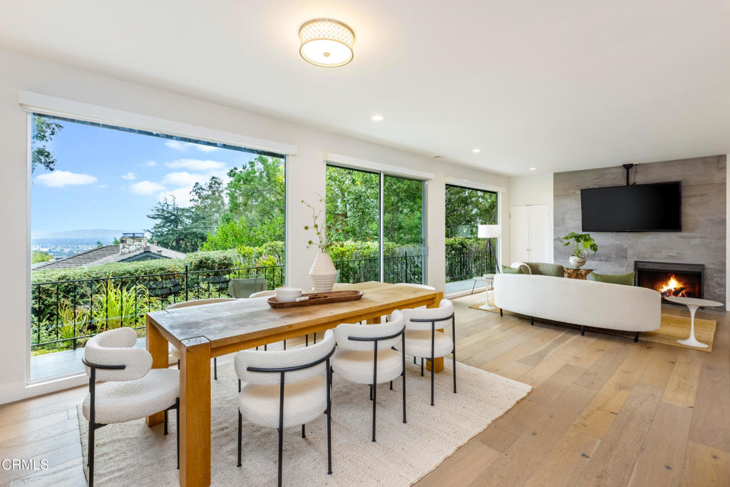 Welcome to this stunning single-story Mid-Century Modern home, offering 4 bedrooms and 4 bathrooms in a timeless, open design. Anchored by a spacious chef's kitchen with a large island, quartz countertops, and a coffee bar. The heart of the home flows seamlessly into the inviting family and living rooms. Floor-to-ceiling windows span the common areas, bathing the interior in natural light and framing serene, forested views that provide rare privacy and tranquility.Entertain with ease around the fireplace or step outside to the sparkling pool and spa perfect for stargazing, lounging, or gathering with friends. Expansive patios and open outdoor space create a natural extension of the living areas, encouraging year-round enjoyment.The master retreat features a custom walk-in closet and a spa-inspired bath with soaking tub, while the additional bedrooms are equally well-appointed and versatile, ideal for family, guests, or office space. Sophisticated bathrooms, a charming laundry room, and ample storage round out the interior.Everyday living is elevated with thoughtful upgrades: dual HVAC system, solar panels, motorized window shades, and copper plumbing. A spacious garage with built-in cabinetry and a lighted workbench adds both convenience and function. Wood oak floors and immaculate finishes combine to make this home equal parts comfort and style. A rare blend of architectural beauty and modern practicality.