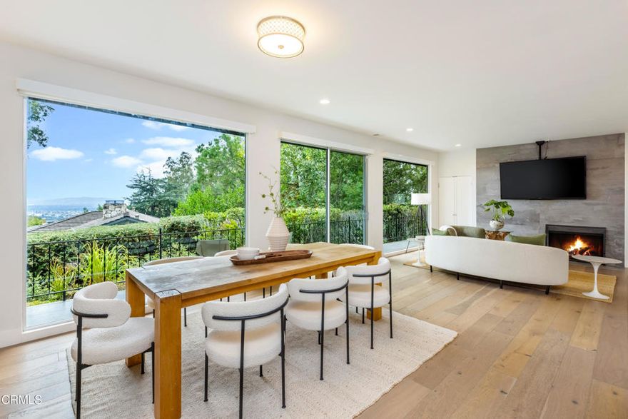 Welcome to this stunning single-story Mid-Century Modern home, offering 4 bedrooms and 4 bathrooms in a timeless, open design. Anchored by a spacious chef's kitchen with a large island, quartz countertops, and a coffee bar. The heart of the home flows seamlessly into the inviting family and living rooms. Floor-to-ceiling windows span the common areas, bathing the interior in natural light and framing serene, forested views that provide rare privacy and tranquility.Entertain with ease around the fireplace or step outside to the sparkling pool and spa perfect for stargazing, lounging, or gathering with friends. Expansive patios and open outdoor space create a natural extension of the living areas, encouraging year-round enjoyment.The master retreat features a custom walk-in closet and a spa-inspired bath with soaking tub, while the additional bedrooms are equally well-appointed and versatile, ideal for family, guests, or office space. Sophisticated bathrooms, a charming laundry room, and ample storage round out the interior.Everyday living is elevated with thoughtful upgrades: dual HVAC system, solar panels, motorized window shades, and copper plumbing. A spacious garage with built-in cabinetry and a lighted workbench adds both convenience and function. Wood oak floors and immaculate finishes combine to make this home equal parts comfort and style. A rare blend of architectural beauty and modern practicality.