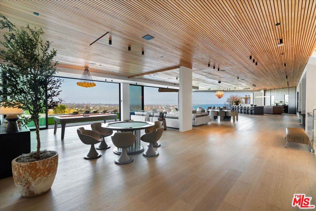 Set above Los Leones Canyon in Pacific Palisades with unobstructed views from the San Gabriel Mountains, Downtown LA to the Pacific Ocean. 766 Paseo Miramar presents a one-of-a-kind estate that balances architectural brilliance with sophisticated interior design. Spanning over 18,000 square feet with six all-ensuite bedrooms on an expansive 47,000-square-foot lot, this magnificent residence was meticulously designed by the renowned architect Tom Leishman with interiors by Michael Palumbo and constructed by the dynamic GME Development. Fully furnished, this home showcases an exquisite collection of custom-designed and imported finishes from Milan's most esteemed houses, including Molteni, Poliform, Modulnova, Misuraemme, Porada, Gallotti, Bisazza, Rugiano, CEA, Lapalma, Flos, and Vismara, to name a few. Even Herms Milan contributed to this estate's refined aesthetic, providing select interior finishes and the elegant powder room mirrors. The curated art collection, featuring works by Paul Gruner and Accardi, was thoughtfully chosen to complement the home's grandeur. Among this estate's many standout features is a divine Poliform kitchen, which encompasses a dedicated chef's kitchen primed for easy, elegant hosting. Throughout the residence, Venetian plaster adds a unique and luxurious touch, enhancing the elevated ambiance. This extraordinary estate boasts eight distinct HVAC zones, ensuring optimal comfort in every corner. A dedicated wellness center offers a sanctuary for rejuvenation, complete with a plunge pool, spa, and sauna, alongside a comprehensive private gym. A breathtaking primary suite spans over 2,500 square feet and features bespoke dual closets exquisitely designed and built by Molteni Milan. For the oenophile, a temperature-controlled wine cellar and an inviting bar create the perfect setting for entertaining. Also for entertaining, the expansive rooftop deck and the lower level ballroom which can be utilized for high-end private events. Outside, find a dramatic 90-foot infinity boomerang pool with an integrated spa that seemingly melts into the horizon, and far-reaching vistas that capture the surrounding canyons and coastline beyond. These are, without a doubt, some of the area's most spectacular, unobstructed views. Rooted in resilience, 766 Paseo Miramar remained intact through the fires that impacted the area. Completed in 2025, this estate presents an opportunity to own in a place shaped by both beauty and resilience.