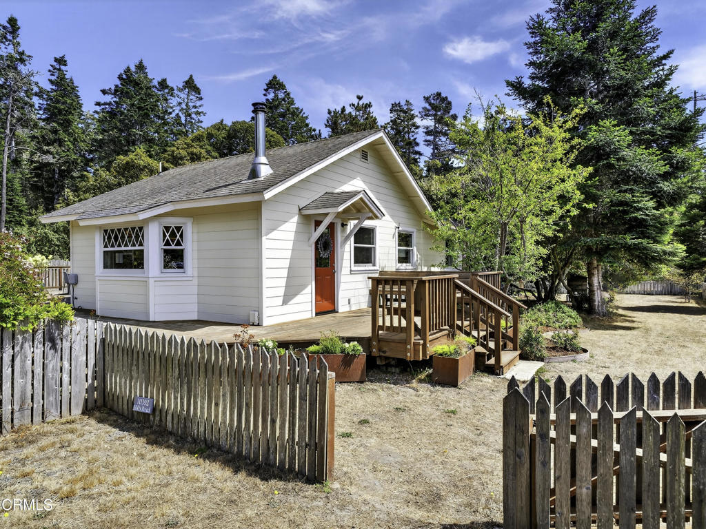 The Cottage Mendocino is nestled happily back from the bluff with ocean views wrapped in redwoods. This colorful 2-bedroom, 1-bath cottage makes a joyful first impression and has been completely renovated with an elegant rustic feel from the magazine-ready gourmet kitchen; to the re-purposed, wide-plank hardwood flooring; to the large picture windows that flood the rooms with bright, natural light. Add to this a wrap-around deck with a sunken spa; built-in indoor/outdoor sound system; and an outdoor area perfect for dining al fresco and you have the complete getaway package. The home and lush gardens are fully fenced and there is a detached 1-car garage. The cottage is a short jaunt to the historic Mendocino Village with restaurants, galleries, art center and quaint shops. Within minutes, you can be gathering driftwood on the beach, kayaking up Big River, or hiking through Russian Gulch State Park. This is a perfect place to switch off and relax while taking in the sounds of the crashing surf and breathtaking beauty of the north coast. The cottage is being sold fully furnished inside and out.