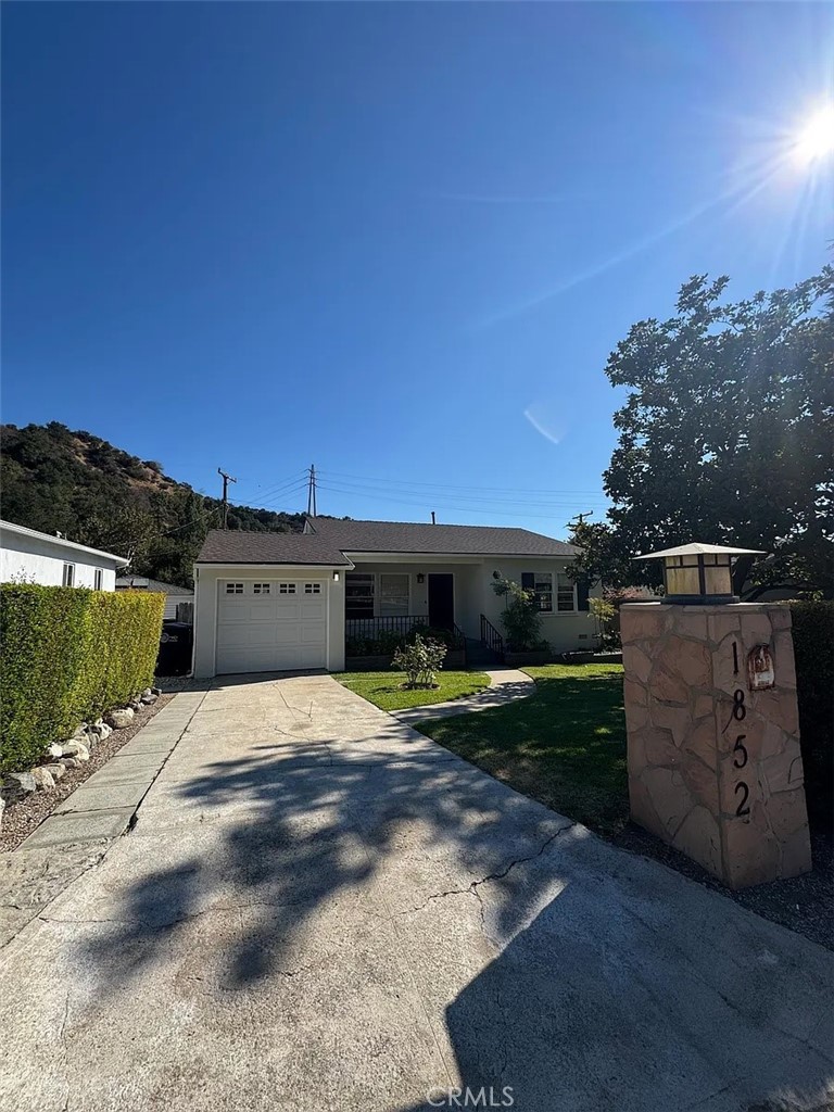 Welcome to 1852 Alpha Rd, a beautifully remodeled cottage in Glendale's highly sought-after Verdugo Woodlands. This charming home features new laminate floors, classic wood windows that fill the space with natural light, and an oversized kitchen with granite countertops, tile flooring, and a wall of glass opening to a romantic covered patio with serene views. Offering two spacious bedrooms plus a versatile den that can serve as a third bedroom or office, the home also includes a full bath and a private primary bath. The private backyard is a true retreat with a lush lawn, mature trees, and garden areas, perfect for entertaining or relaxing outdoors. Additional highlights include central air and heating, an attached garage, laundry area, and extra storage. Situated in one of Glendale's most desirable areas, this home combines peaceful living with convenient access to shopping, dining, freeways, and top-rated schools including Fremont Elementary, Rosemont Middle, and Crescenta Valley High.