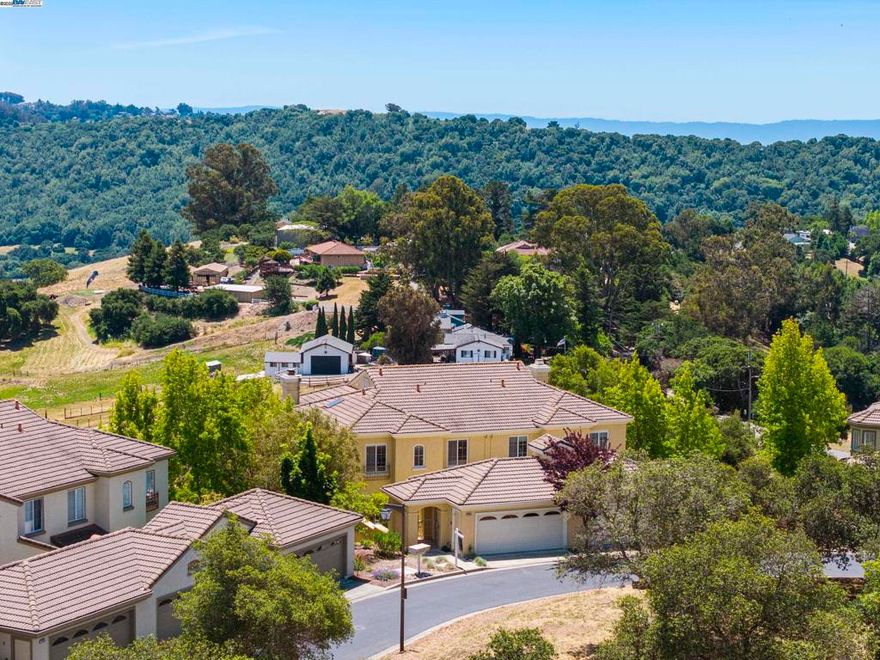 Gorgeous Updates & Views in Prestigious Palomares Hills! Enjoy the comfort and privacy of a single-family home feel in this spacious townhome. This home features brand-new bright quartz kitchen countertops and backsplash, freshly painted cabinetry, new interior paint, and sleek new waterproof wood flooring. The versatile floor plan includes a convenient downstairs bed and full bath—perfect for guests or multi-gen living—as well as a large storage closet that can be transformed into your own personal wine cellar. With 2,379 square feet of thoughtfully designed living space, this home showcases some of the most spectacular canyon and partial bay views in the neighborhood. Freshly painted and featuring a newer fence, this move-in-ready home offers modern comforts like air conditioning, ceiling fans, and central heating. Upstairs, enjoy three additional bedrooms, including a spacious primary suite with double closets. Residents are treated to resort-style amenities including multiple swimming pools, tennis, basketball, and pickleball courts, scenic walking trails, a community park, private security patrol, and more. Located within the award-winning Castro Valley School District and offering easy access to shopping and major  freeways, this home blends style, comfort, and convenience!