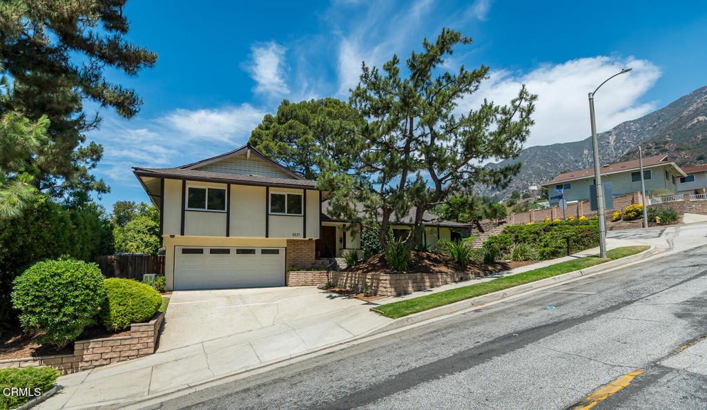 Set in the highly sought-after Pinecrest neighborhood, this stylish 4-bedroom, 3-bath home offers 2,292 sq ft of well-maintained living space on a generous 10,742 sq ft lot. Built in 1965, the home showcases timeless Mid-century architectural details--clean lines and natural elements, large picture windows, and classic parquet wood flooring. This home is ready for reimagining, or move-in ready! Inside, you'll find a spacious layout designed for comfort and function. The large living room flows seamlessly into the dining room, while the kitchen--complete with a breakfast bar, chic stone fireplace, and direct access to the patio--serves as the heart of the home. A flexible downstairs guest suite with separate access can also function as a family room, home office, or creative studio. Retreat upstairs to the spacious primary suite, and two additional bedrooms with hall bath, offering both privacy and practicality for family or guests. The sprawling flat backyard with covered patio is perfect for entertaining or relaxing in private, and there's plenty of space for a pool or play equipment. There is ample storage throughout the house and in the convenient, attached two-car garage. Located close to local parks, shopping, and award-winning La Crescenta schools, this architectural gem offers the perfect blend of style, space, and convenience.
