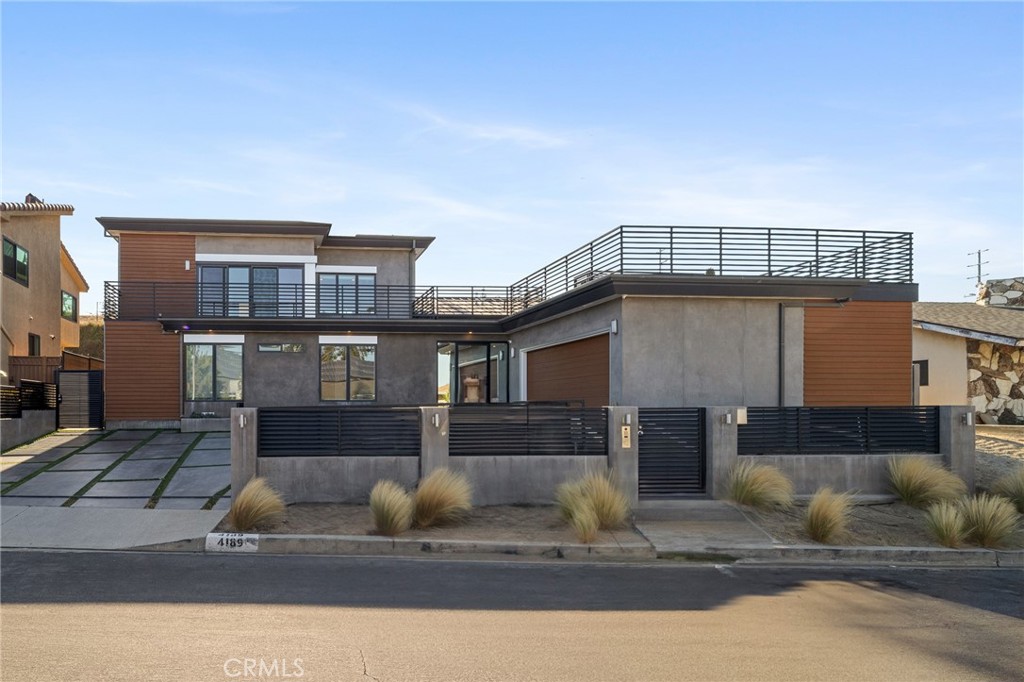 Perched in the exclusive Baldwin Vista Hills and just moments from Culver City, this modern contemporary masterpiece built in 2022 offers an unparalleled blend of luxury, technology, and lifestyle. Boasting 5 bedrooms, 5 bathrooms, and 3,369 square feet of thoughtfully designed living space, this home features designer finishes and a seamless open-concept layout ideal for both entertaining and everyday living. The heart of the home is a chef’s dream kitchen, outfitted with an oversized quartz island, top-of-the-line appliances, custom cabinetry, and dual sinks. The sophisticated living areas are enhanced by wide plank flooring, a floating staircase with glass railing, and integrated smart home features including a Russound audio system, Lutron lighting, and Nest thermostats in every bedroom. The lavish primary suite offers a private sanctuary with a spa-inspired bathroom, soaking tub, and frameless glass shower and walk in closet. Each additional bathroom showcases floating vanities and sleek, high-end finishes. A spacious bonus room provides flexibility as a gym, office, or creative space. Enjoy two private balconies, a rooftop terrace with panoramic views of the city skyline, and a beautifully landscaped backyard oasis with a pool, spa, and custom outdoor kitchen with built-in BBQ. Tucked behind a gated entry with drought-tolerant landscaping, this home offers direct semi-private access to Kenneth Hahn State Park, where miles of scenic hiking trails await. Located just minutes from Whole Foods, Erewhon, the Culver City stairs, and Downtown Culver City's renowned dining and shopping, this home combines tranquility, convenience, and modern luxury in one exceptional package.