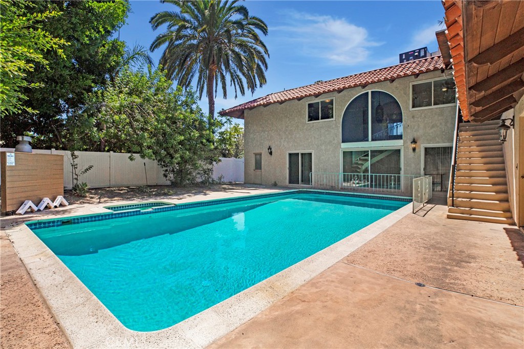This approximately 3698 sq ft palatial home, a combination of Spanish Revival features and Romanesque landscaping is reminiscent of the glory days of Hollywood grandeur. Attractive, wide steps lead into a walkway that proceeds to the double wooden door entrance. Once inside, a wide and roomy foyer provides access to a panorama of rooms including 6 bedrooms and 3 1/2 baths, each with a combination of practical and esthetically pleasing features. Built to impress, this beauty maintains many of the original upscale features like custom built-in’s, an abode-style fireplace as well as a more modern conventional one, rounded archways, an elegant curved stairway leading to the second floor, and walk-in closets that can also be used as dressing rooms. The primary closet is even equipped with cedar panels. A full service kitchen complete with inset stove top and storage galore awaits food preparation for small soirees or gala gatherings. Several raised platform areas provide both interest and ambience as well as create a separate space without walls or dividers. In addition to spacious rooms inside are generous outside covered walkways, and a gorgeous pool and hard scape patio This backyard area is conveniently accessed via the first floor sliding doors and by the outdoor stairway that villa-like, leads from the second story. A sweeping driveway ushers vehicular traffic to a huge enclosed three car garage in the back of the property. La Loma is primarily a residential neighborhood that reflects the care and attention residents put in their properties. Plenty of business and parks are nearby as are small businesses that provide a myriad of goods and services. Definitely a neighborhood feel within proximity to the city and its amenities.
