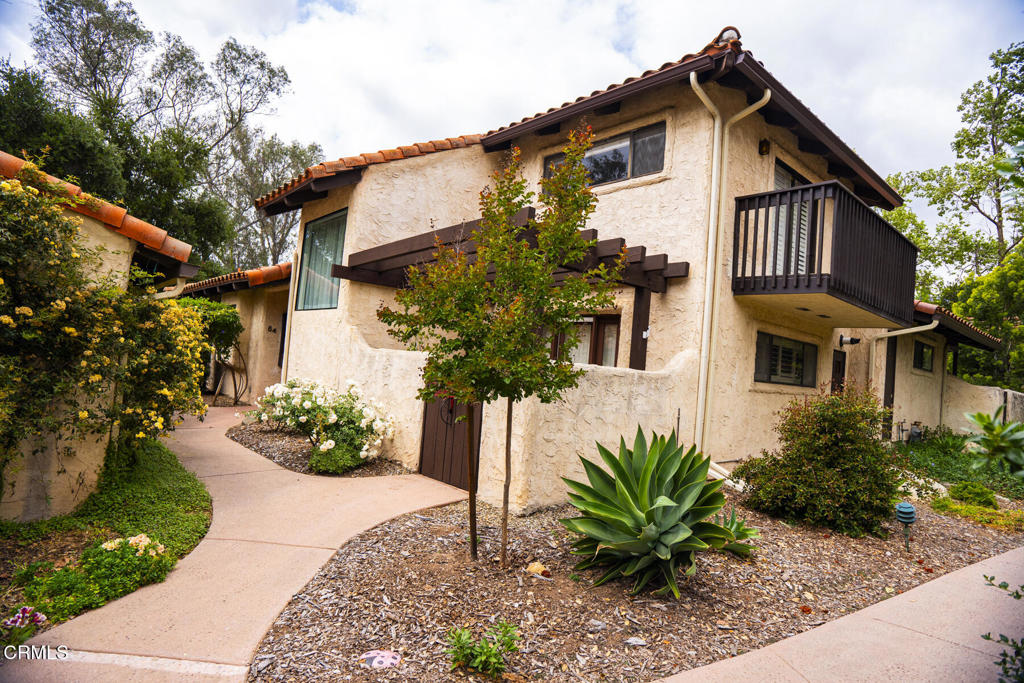 Come home to the blue sky and sheltering mountains of Ojai, to the prime location of this three bedroom three bath Hitching Post condo with a detached two car garage and room for extra vehicles in the community boat/RV lot. Relax in the spa, swim in the pool, and ride downtown or to the beach on the bike path. In the living room, a vaulted ceiling and gas fireplace create a cozy mood. The dining area is just off the kitchen. The solarium expands the living space for entertaining and can allow you to garden protected from wildlife. The lower level primary bedroom opens to an enclosed, gated patio. Upstairs, two bedrooms provide flexibility, accommodating guests, a large household, an art space, or an office. Washer and dryer are tucked away in a closet. Most everything you need is close by, but whatever you may want outside the Ojai Valley isn't too far away, a half hour drive to the Ventura beaches, an hour's drive to Santa Barbara, or a longer drive to LA, and returning to the friendly community and natural beauty of Ojai makes it nice to come home.