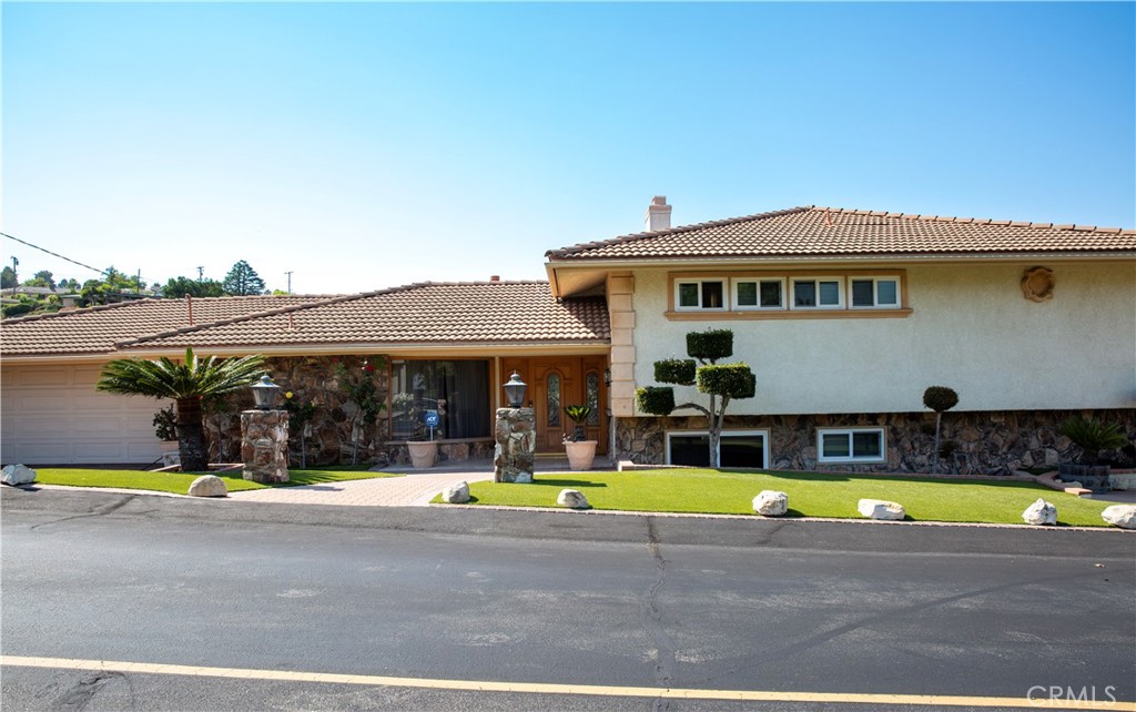 Nestled on a serene and private street in Rancho Palos Verdes, this stunning tri-level home offers a perfect blend of luxury and comfort. With 3 spacious bedrooms and 2.5 modern baths, this home boasts breathtaking canyon and city views of the Los Angeles basin, including the iconic downtown skyline. Step inside to experience a meticulously designed layout tailored for both comfort and entertaining. With a freshly painted interior, the main level showcases a kitchen with elegant wood cabinetry, a Sub-Zero refrigerator, a new dishwasher, and generous counter and storage space. Adjacent to the kitchen is a welcoming dining area, complemented by a formal dining room on the other side of the kitchen. A custom wet bar enhances the living space, while a convenient laundry room provides direct access to a spacious two-car garage equipped with a Tesla wall charger. Upstairs, a formal living room features expansive windows that offer impressive city views. The large primary suite includes a walk-in closet and a dual-sink bathroom, creating a private haven for relaxation. The lower level offers a versatile additional living room or den, two supplemental bedrooms, and a full bathroom with a sizeable walk-in tub. Outside, the private backyard presents a peaceful retreat with lemon trees and garden beds, perfect for home gardening. The front yard affords additional parking options for multiple vehicles, including accommodations for an RV or boat on a paved pad. This property is ideally located near Miraleste Library and Miraleste Intermediate School, as well as in close proximity to golf courses, hiking trails, beaches, shopping, and dining. Don't miss the opportunity to make this beautiful Rancho Palos Verdes retreat your new home!