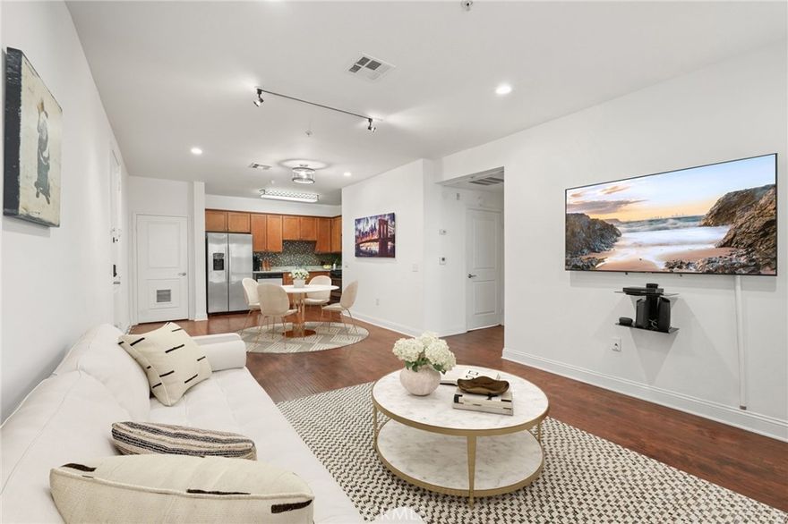 Welcome to this bright and spacious 2-bedroom, 2-bathroom condo located in a secure, Mediterranean-style building in the heart of North Hollywood. This beautifully maintained unit offers an open-concept layout with engineered hardwood flooring and high ceilings. The living room features large windows that fill the space with natural light, along with a sleek gas fireplace that adds warmth and modern appeal.

The kitchen is equipped with granite countertops, stainless steel appliances, and ample cabinetry, creating a seamless flow between the dining and living areas. For added convenience, the home includes an in-unit stacked washer and dryer.

Both bedrooms are generously sized, and the primary suite features a walk-in closet and an en-suite bathroom with dual vanities, granite counters, and a soaking tub/shower combination. The second bedroom is spacious and conveniently located near the full guest bathroom.

The community offers secure controlled access, gated underground parking, a fitness center, and a beautifully tiled central courtyard with seating areas and decorative details. Residents also enjoy access to a rooftop deck with sweeping views of the San Fernando Valley. The HOA includes water, trash, elevator maintenance, and coverage for all building-related issues, leaving the owner responsible only for their electric and gas bills.

Located just minutes from the NoHo Arts District, major studios, restaurants, shopping, and freeway access, this move-in-ready home offers comfort, convenience, and modern living in one of LA’s most desirable neighborhoods.