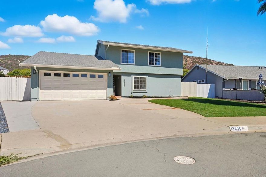 Beautifully remodeled 5-bedroom, 3-bathroom home on a quiet cul-de-sac with no neighbors behind and your own private PebbleTec pool, in the heart of Poway. Set on a 7,200 sq ft lot, this home features an open floor plan, vaulted ceilings with skylights, and luxury vinyl plank flooring throughout. The main level offers three bedrooms and two bathrooms, including a spacious primary suite with walk-in closet, walk-in shower, and French doors leading to the backyard. Upstairs includes two more bedrooms, a full bath, and a finished attic space ideal for storage or a playroom. Upgrades include a modern kitchen with quartz countertops, tile backsplash, new cabinets with gold-tone hardware, stainless steel appliances, and new roof. Bathrooms feature quartz counters, updated vanities, ceramic-tiled showers, and designer fixtures. Additional highlights include recessed lighting, dual-pane windows, central heat and A/C, fresh interior and exterior paint, tankless water heater, and laundry hook-ups in the garage. The private backyard is perfect for entertaining, and there's a two-car garage plus plenty of driveway parking. Located near top-rated Poway schools, shopping, dining, Lake Poway, hiking trails, and easy freeway access. Don’t miss this turnkey gem!