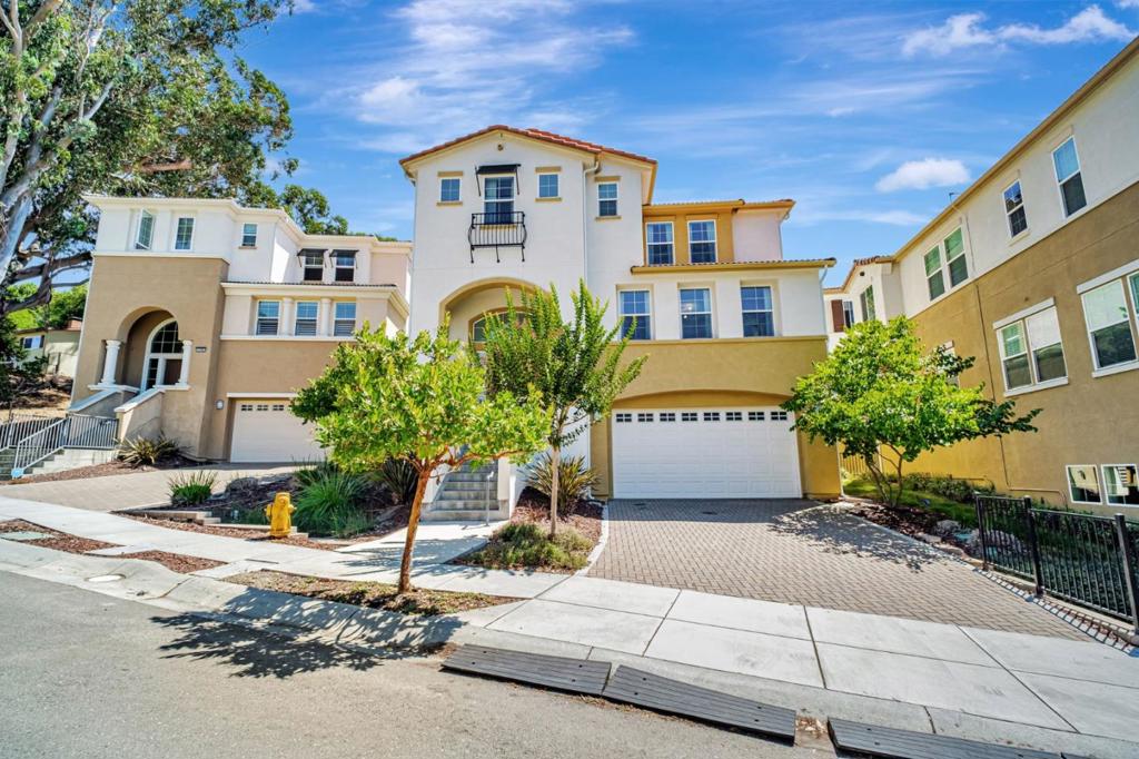 Welcome to Your Hayward Hills Retreat! Discover this Santa Barbara-style 5BD/5.5BA home built in 2019, nestled in the peaceful hills above Cal State East Bay. Thoughtfully designed with an open-concept layout, every bedroom features an en suite bath. Enjoy hand-set tile flooring, Craftsman-style finishes, and an abundance of natural light throughout. The gourmet kitchen boasts dual islands, quartz counters, Bosch appliances, and custom beech cabinetry. The spacious primary suite offers a walk-in closet and a spa-like bath with a soaking tub and oversized shower. Outdoor living is a dream, complete with a private backyard, electric fireplace, and serene hilltop views that are often visited by deer. Additional highlights include Tesla solar (owned), EV plug, tech infrastructure, tankless water heater, and a 3-car garage with flex space for a gym or game area. Minutes from schools, BART, hiking trails, and Stonebrae Country Club. This is luxury living with nature at your doorstep.