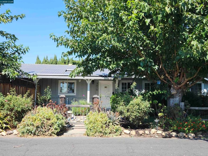 Welcome to your own private retreat! This beautifully landscaped property features a charming cottage/ADU and a spacious single-level home tucked away on a peaceful court. Relax on the inviting front porch before stepping inside to a bright, newly remodeled kitchen with all new appliances, a 6-burner gas stove, stunning countertops, and a deep Kohler sink—perfect for entertaining or simply enjoying everyday luxury.The large living room offers a cozy wood-burning fireplace and two window seats overlooking the heated swimming pool. Outdoors, you’ll find mature landscaping, a separately fenced garden with raised beds, and a private backyard designed for gatherings or quiet relaxation. The ADU is fully equipped with a kitchenette, full bath, new flooring, fresh paint, and a modern mini split system—ideal for guests, extended family, or rental income. Tesla solar (leased) adds energy efficiency to this exceptional property. Located in a wonderful neighborhood, this home blends comfort, style, and practicality. Don’t miss the opportunity to make this retreat your own!