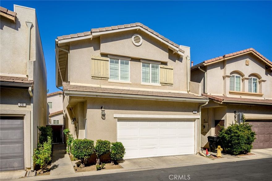 Turnkey and smart-upgraded, this 3-bedroom, 3-bath home at 9001 Owensmouth Ave Unit 27 blends modern convenience with inviting indoor-outdoor living in a peaceful gated community with security cameras. An open-concept living and dining area centers around a cozy gas fireplace and features ceiling-mounted 5.1-channel speakers for immersive entertainment. Sliding doors lead to a private patio finished with slate stone flooring and a small vegetable garden area—ideal for relaxing or casual dining. The refreshed kitchen is thoughtfully appointed with newly painted cabinets, quartz countertops, a gas range with a smart Wi-Fi microwave above, a low-decibel dishwasher, refrigerator, and a reverse osmosis alkaline drinking-water connection. Upstairs, south-facing bedroom windows are accented with plantation-style shutters that enhance natural light and privacy. Everyday comforts include an in-unit washer/dryer and an efficient tankless water heater for on-demand hot water. Added peace of mind comes from a wired Nest outdoor camera and an Eufy video doorbell. Move-in ready and well located within the community, this residence offers the ease of modern systems, tasteful updates, and a flexible layout for today’s lifestyle.