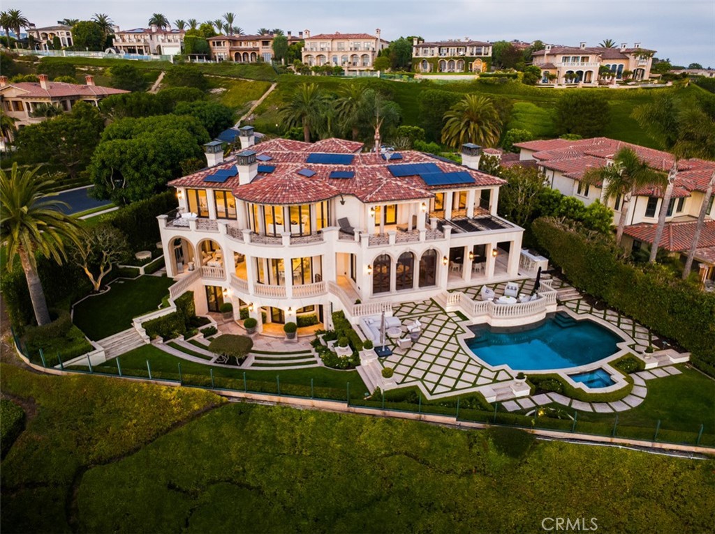 A Singular Coastal Estate with Iconic Views Perched atop one of the most coveted parcels in the prestigious guard-gated enclave of Pelican Crest, 22 Pelican Crest Drive is a newly reimagined architectural masterpiece that sets a new standard for coastal luxury. Positioned on an expansive pie-shaped lot of approximately 18,550 sq ft, this estate captures breathtaking sit-down views of the Pacific Ocean, Catalina Island, and the glittering city lights from nearly every room. Encompassing over 10,000 sq ft of sophisticated living space, the residence seamlessly blends grand-scale entertaining with intimate everyday living. A dramatic double-height foyer with soaring vaulted ceilings and a striking modern spiral glass staircase creates an unforgettable first impression, while walls of glass and open-concept design invite natural light and showcase the spectacular vistas beyond. This five-bedroom, seven-and-one-half-bathroom estate has been meticulously renovated with bespoke finishes and thoughtful details throughout. The primary suite is a sanctuary unto itself, featuring panoramic ocean views, a private sitting room/retreat, an oversized spa-inspired bath, and a couture-quality custom closet. Designed with effortless indoor-outdoor flow, the property boasts multiple terraces and entertaining spaces to capture sunsets over the Pacific. The home features all of the expected modern indulgences of a custom estate including movie theater, gym, chef's kitchen, oversized walk in wine cellar, billiards & tasting area, bar, outdoor kitchen, and resort style pool with multiple lounging and sitting areas. The property location and lush landscaping provide unrivaled privacy and curb appeal, befitting this world-class residence. Turn-key and timeless, 22 Pelican Crest is more than a home—it’s a statement of refinement and a rare opportunity to own a legacy property in one of Southern California’s most exclusive coastal communities.