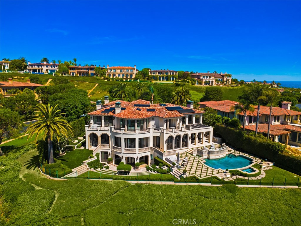 A Singular Coastal Estate with Iconic Views Perched atop one of the most coveted parcels in the prestigious guard-gated enclave of Pelican Crest, 22 Pelican Crest Drive is a newly reimagined architectural masterpiece that sets a new standard for coastal luxury. Positioned on an expansive pie-shaped lot of approximately 18,550 sq ft, this estate captures breathtaking sit-down views of the Pacific Ocean, Catalina Island, and the glittering city lights from nearly every room. Encompassing over 10,000 sq ft of sophisticated living space, the residence seamlessly blends grand-scale entertaining with intimate everyday living. A dramatic double-height foyer with soaring vaulted ceilings and a striking modern spiral glass staircase creates an unforgettable first impression, while walls of glass and open-concept design invite natural light and showcase the spectacular vistas beyond. This five-bedroom, seven-and-one-half-bathroom estate has been meticulously renovated with bespoke finishes and thoughtful details throughout. The primary suite is a sanctuary unto itself, featuring panoramic ocean views, a private sitting room/retreat, an oversized spa-inspired bath, and a couture-quality custom closet. Designed with effortless indoor-outdoor flow, the property boasts multiple terraces and entertaining spaces to capture sunsets over the Pacific. The home features all of the expected modern indulgences of a custom estate including movie theater, gym, chef's kitchen, oversized walk in wine cellar, billiards & tasting area, bar, outdoor kitchen, and resort style pool with multiple lounging and sitting areas. The property location and lush landscaping provide unrivaled privacy and curb appeal, befitting this world-class residence. Turn-key and timeless, 22 Pelican Crest is more than a home—it’s a statement of refinement and a rare opportunity to own a legacy property in one of Southern California’s most exclusive coastal communities.