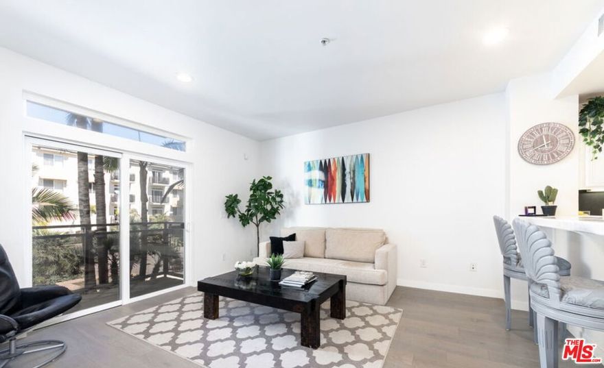 Stylish Coastal-Inspired Corner Unit in the Heart of Playa Vista Step into refined coastal living with this beautifully renovated residence in the highly desirable Crescent Walk community of Playa Vista. Designed with a light beach aesthetic, this sophisticated corner unit is bathed in natural light and offers an open-concept floor plan featuring hardwood floors, recessed lighting, and motorized shades for effortless comfort. The modern kitchen boasts a chic glass tile backsplash and premium appliances, perfectly suited for entertaining or everyday ease. Additional highlights include in-unit washer and dryer, central heating and air conditioning, designated garage parking, and access to EV charging stations. This unit can be leased, furnished or unfurnished. High speed Wi-Fi and cable TV are included in the rent for your convenience. Crescent Walk residents enjoy access to a host of luxury amenities, including an Olympic-sized pool with private cabanas, a soothing spa, a state of the art fitness center, and 24-hour security patrol. Beyond the front door lies the vibrant Playa Vista community renowned for its lush parks, farmer's markets, and curated retail and dining experiences. Enjoy easy access to Runway Playa Vista, Whole Foods, Cinemark, and a dynamic social calendar filled with concerts, yoga in the park, and seasonal events. Tech and creative professionals will also appreciate the proximity to Silicon Beach, home to major companies like Google, YouTube, and Facebook. Available furnished or unfurnished with pricing based on furnishing preferences and lease duration.