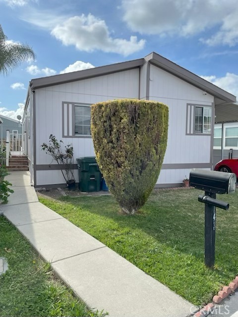 Welcome to Pomona Islander, an establish Community in the city of Pomona. This home with 3 bedrooms and 2 bathrooms nice kitchen and good size living room and dining area located on a good size lot with side yard and backyard. Laundry room is equipped with washer and dryer hook-ups and has access to the attached covered carport. Nice quite neighborhood, easy access to 57 and 10 freeways, and Shopping nearby and the View of Hills in Spring are Beautiful. Enjoy summer at the swimming pool.