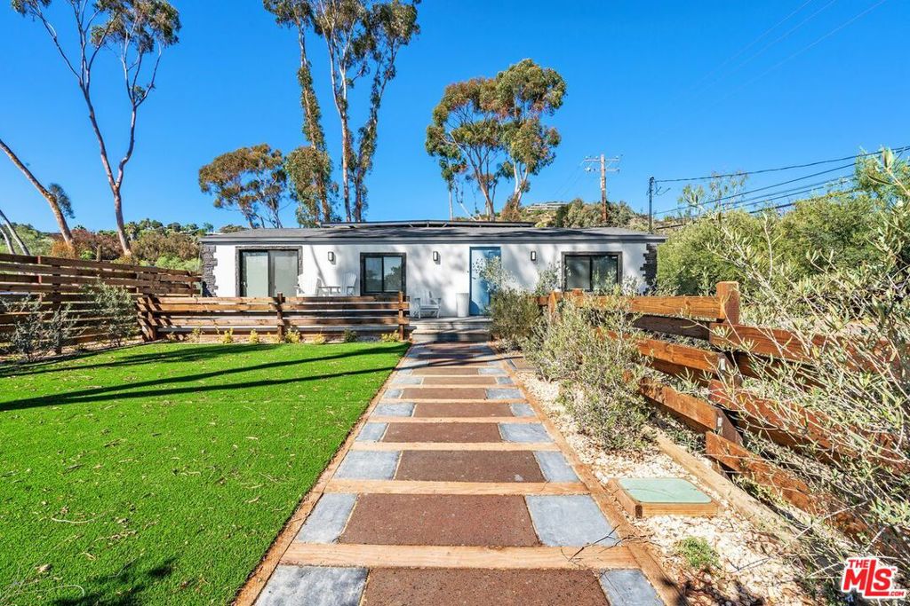 Recently renovated gated single-story ranch house w/ ocean view, large front yard w/ patio and mature landscaping. The living area features French white oak hardwood flooring, L-shaped sectional, gas fireplace, large TV and custom art, while the kitchen features an island w/bar seating, quartz countertops and brand-new stainless-steel appliances. The Primary Suite is well appointed w/ an ocean view, direct patio access and features a king-size bed, large TV and coastal art. Just down the hallway is a secondary bedroom that also comes w/ an ocean view, queen-size bed and full size stand alone mirror. Lastly - there is a second full bathroom, laundry room w/ brand-new washer/dryer and rear access to an additional large patio. This property is a multi-acre ranch that rests adjacent to miles of highly desirable hiking and riding trails, which the Tenant has the opportunity to participate in the Equestrian lifestyle if he or she desires. Located right across from world class dining, such as Geoffrey's and one of the sandiest beaches in Malibu - Escondido Beach.