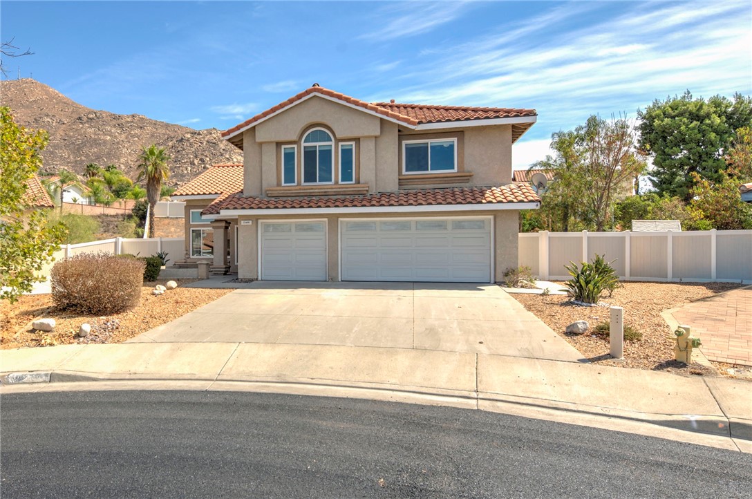 Discover this stunning move-in ready home nestled at the end of a peaceful cul-de-sac in Moreno Valley's desirable Box Springs neighborhood. This beautifully updated two-story residence offers approximately 2,321 sq. ft. of living space with 5 bedrooms, 2.5 bathrooms, and a three-car garage, all situated on an expansive 13,068 sq. ft. (0.31-acre) lot with picturesque mountain views—setting it apart from other properties with similar square footage. Built in 1992, the home showcases an impressive list of recent upgrades including a brand-new HVAC system with outdoor condensing unit installed in August 2025, fresh paint throughout, and refreshed kitchen cabinets that deliver a crisp, modern aesthetic. The interior features soaring vaulted ceilings, expansive windows that bathe the home in natural light, and an open floor plan with tile flooring downstairs flowing seamlessly from the updated kitchen to the family room complete with wet bar. Upstairs, each bedroom is equipped with ceiling fans for year-round comfort. Additional highlights include an epoxy-coated garage floor for durability and style, plus exceptional outdoor living with a covered patio and spacious yard enclosed by attractive white vinyl fencing. The backyard features a concrete walkway and patio with a gazebo. This remarkable property perfectly combines generous living space, quality finishes, and thoughtful enhancements with rare lot size and development potential in an ideal location.