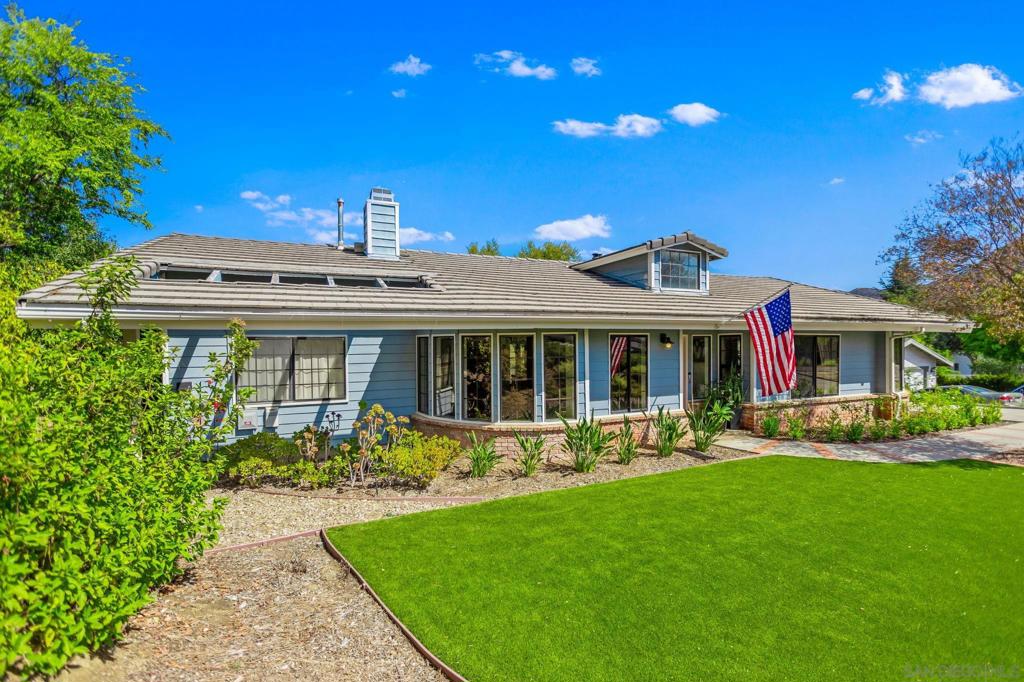 Updated, single-story home in San Diego Country Estates. This comfortable home boasts large living and family room areas filled with windows, offering abundant natural light. Both rooms feature fireplaces: a traditional fireplace in the living room, a wood-burning stove with a floor-to-ceiling hearth in the family room. The kitchen opens to the family room, with counter bar seating, ample storage, and access to the dining room and outdoor patio. Three spacious bedrooms, two baths, and a laundry room complete the home. Multiple exterior doors lead out to a large elevated patio, perfect for entertaining or dining al fresco! Unique to the area, this home's driveway wraps below the patio, connecting to a massive two-car garage with an attached 23-foot-deep RV garage. This space is perfect for additional storage, a shop, or storing a boat or RV! The home also includes a paid solar system, providing low to no-cost energy. At just over half an acre, the property features a huge, fully fenced backyard with the space and potential for an additional ADU or private pool. The home is within walking distance to James Dukes Elementary and 10-15 minutes from downtown Ramona. Experience all that San Diego Country Estates has to offer, including the clubhouse with a restaurant, sports bar, event space, boutique hotel, 18-hole golf course, tennis/pickleball courts, and a community pool and spa. The community also provides a vast trail system for horse riding, biking, or hiking, and a 5-acre community park with a second pool, a bandstand, and grassy areas for picnics and community events.