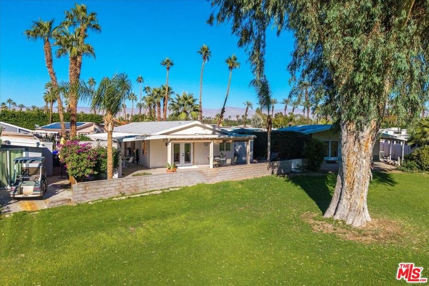 Introducing another stunning creation by Rick Metz, one of the Coachella Valley's most talented residential designers. This unique reimagining and repurposing of a mobile home interior is sure to inspire a "Wow!" the moment you step foot trough the double-door entry and into the grand foyer. Offered turn-key & fully furnished, this totally remodeled & renovated property features a two bedroom / two bath primary residence AS WELL AS an attached private casita / guest house / in-law suite - complete with it's own separate entry, kitchen, bath, laundry, and private driveway! This clever use of space enables a homeowner to take on a "roommate" and offset monthly living expenses while still enjoying the privacy of their own residence. Located not far from a community pool, spa, sauna & gym, the main residence also features an updated kitchen w/ high-end appliances & large walk-in pantry, a formal dining room, living room with vaulted ceilings, two fully renovated baths, dual but separate vanities in the primary bath, laundry room, two private covered patios, stunning views of the golf course and mountains, a koi pond (you provide the koi) as well a utility shed, golf cart garage, attached carport with room for multiple cars... The list goes on and on.  Date Palm Country Club is THE premier 55+ MH golf community in Cathedral City. Monthly lot rent is only $1,650. Amenities and activities abound. See it today!